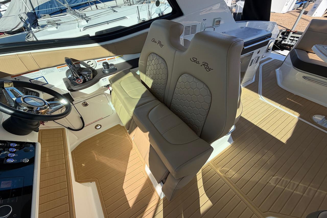 2023 Sea Ray Sundancer 320 Outboard cockpit with beige seating and modern controls.