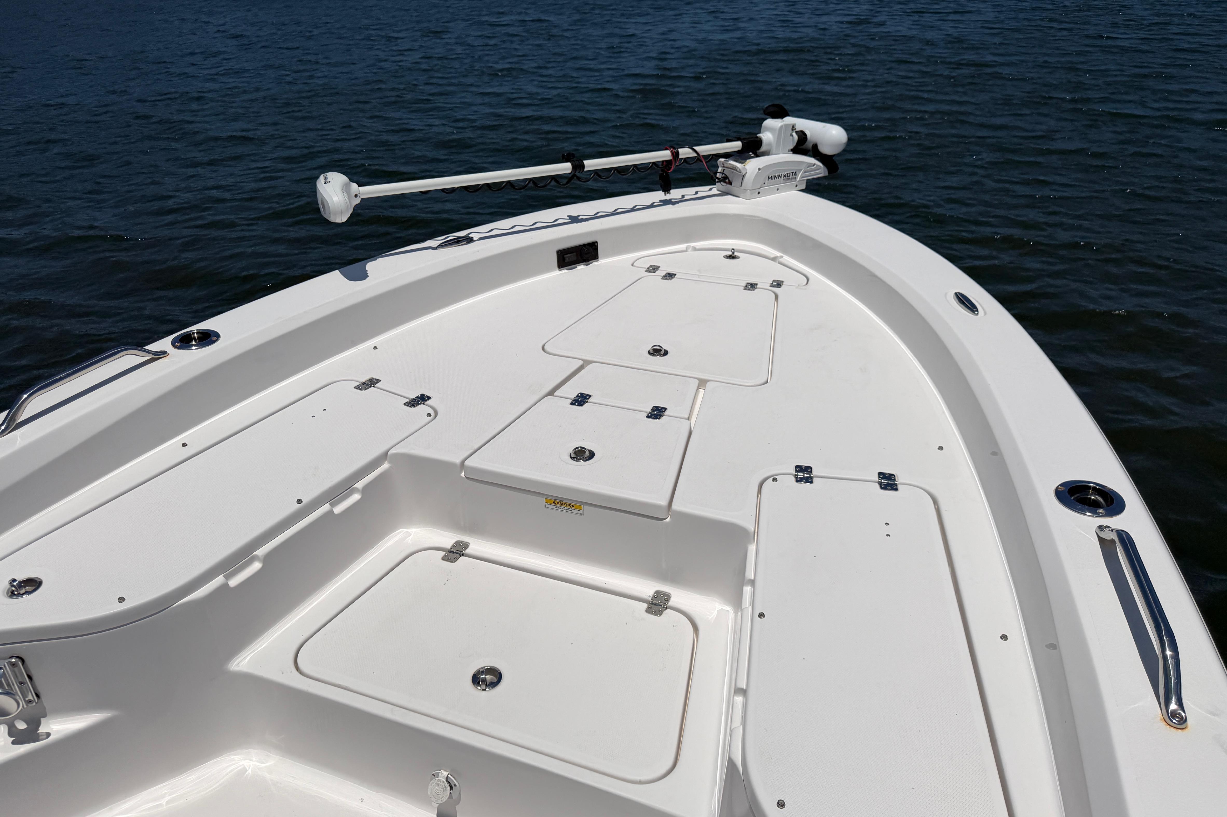 2022 Aquasport 230 Pro Bay boat deck with storage compartments and trolling motor.
