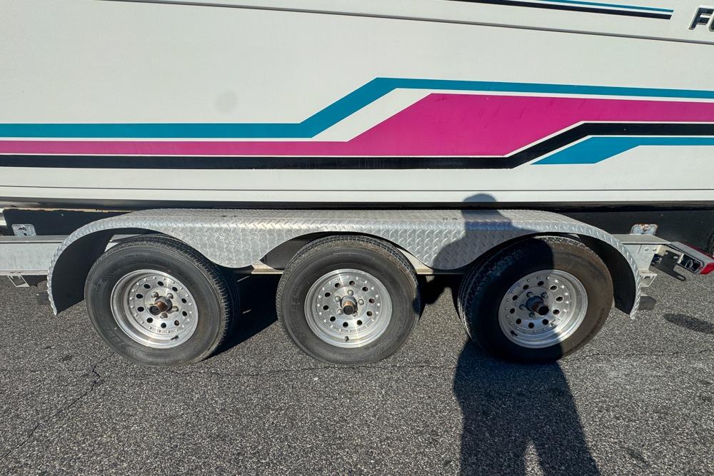 1989 Formula 292 SR-1 boat trailer with colorful stripes and triple axle wheels.