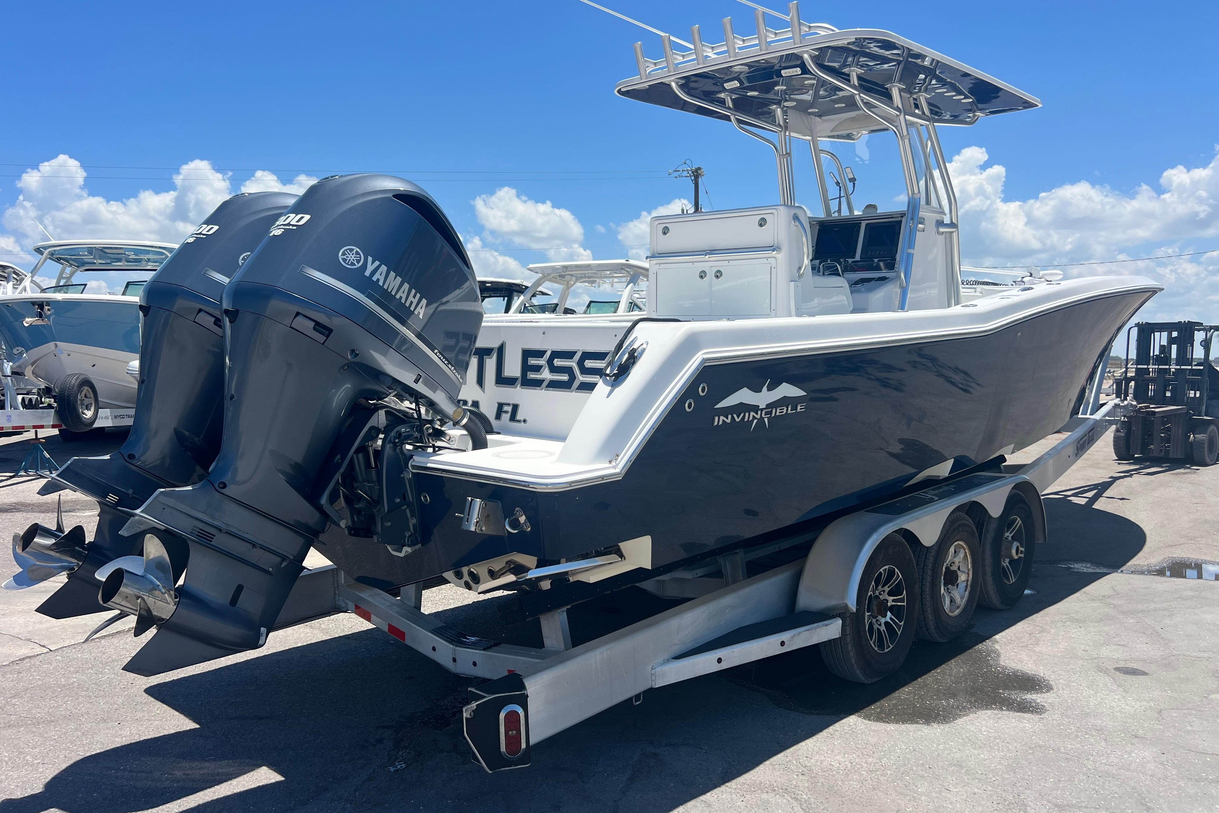 2012 Invincible 33 Open Fisherman boat with twin Yamaha engines on a trailer.