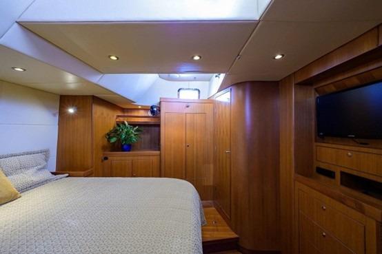 Luxurious cabin interior of 2009 Hylas 70 yacht with wood paneling and modern amenities.