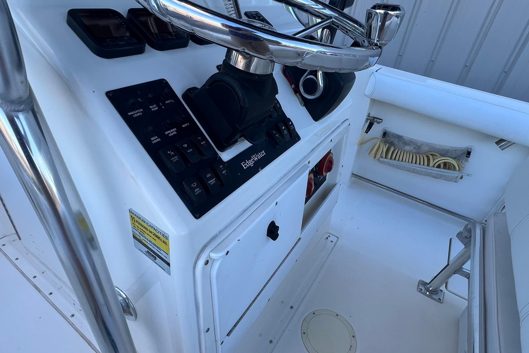 2006 Edgewater 245CC boat console with steering wheel and control panel.