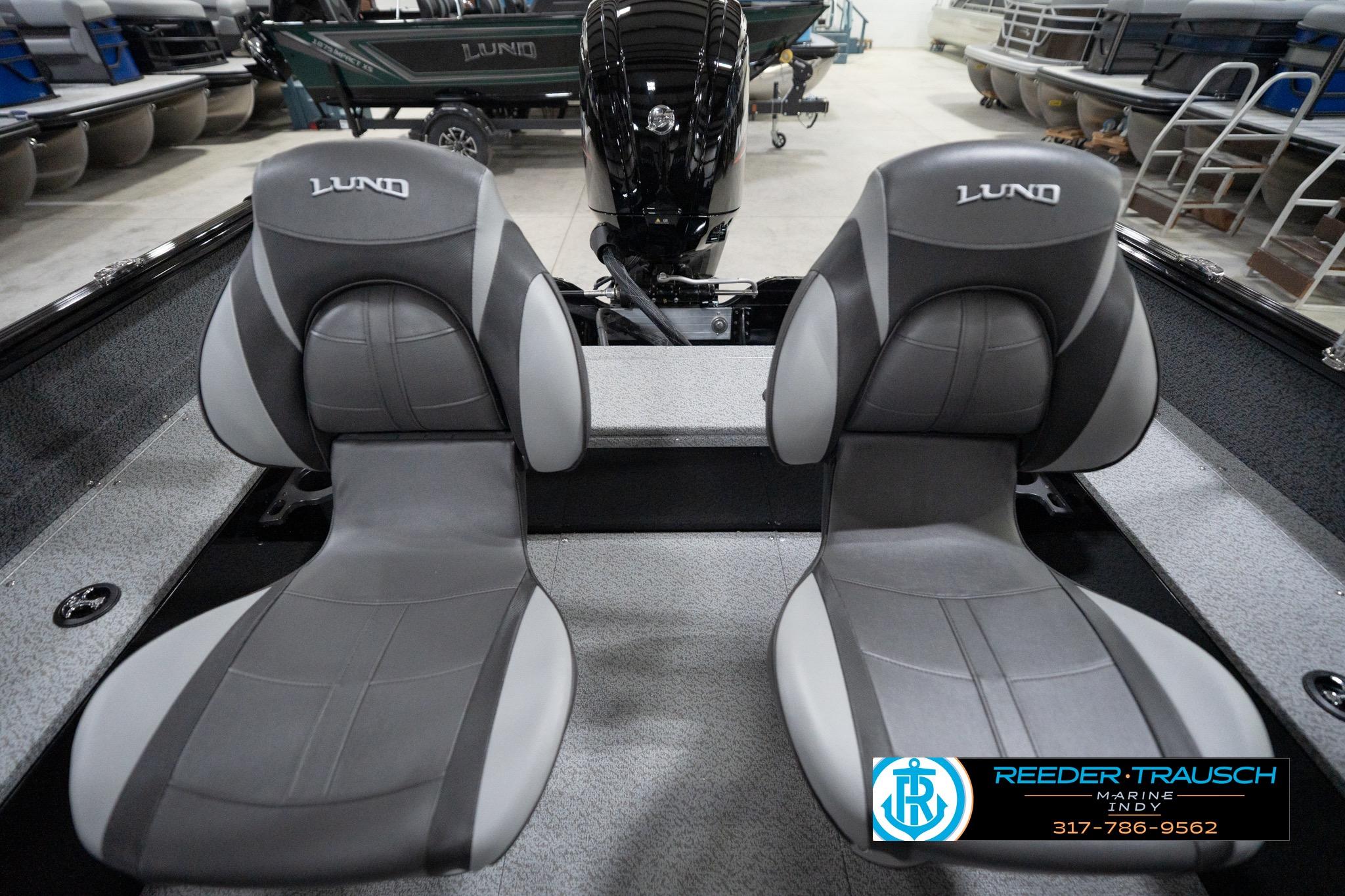 2026 Lund 1800 Explorer Sport boat seats in showroom, featuring sleek gray design.