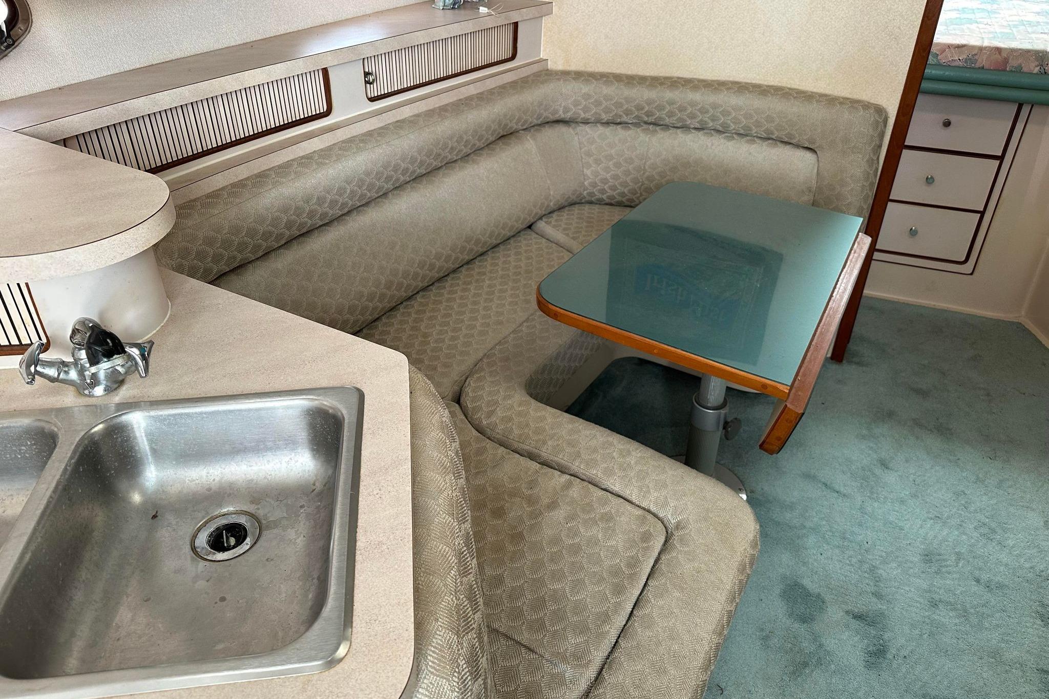 1992 Regal Commodore 400 interior with kitchenette, sink, and cozy seating area.