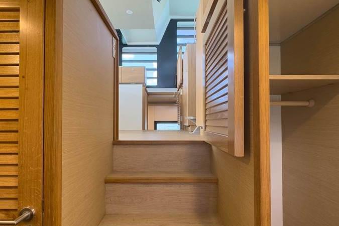 Modern interior of 2024 Kayflo Stay-Ô with wooden stairs and storage.