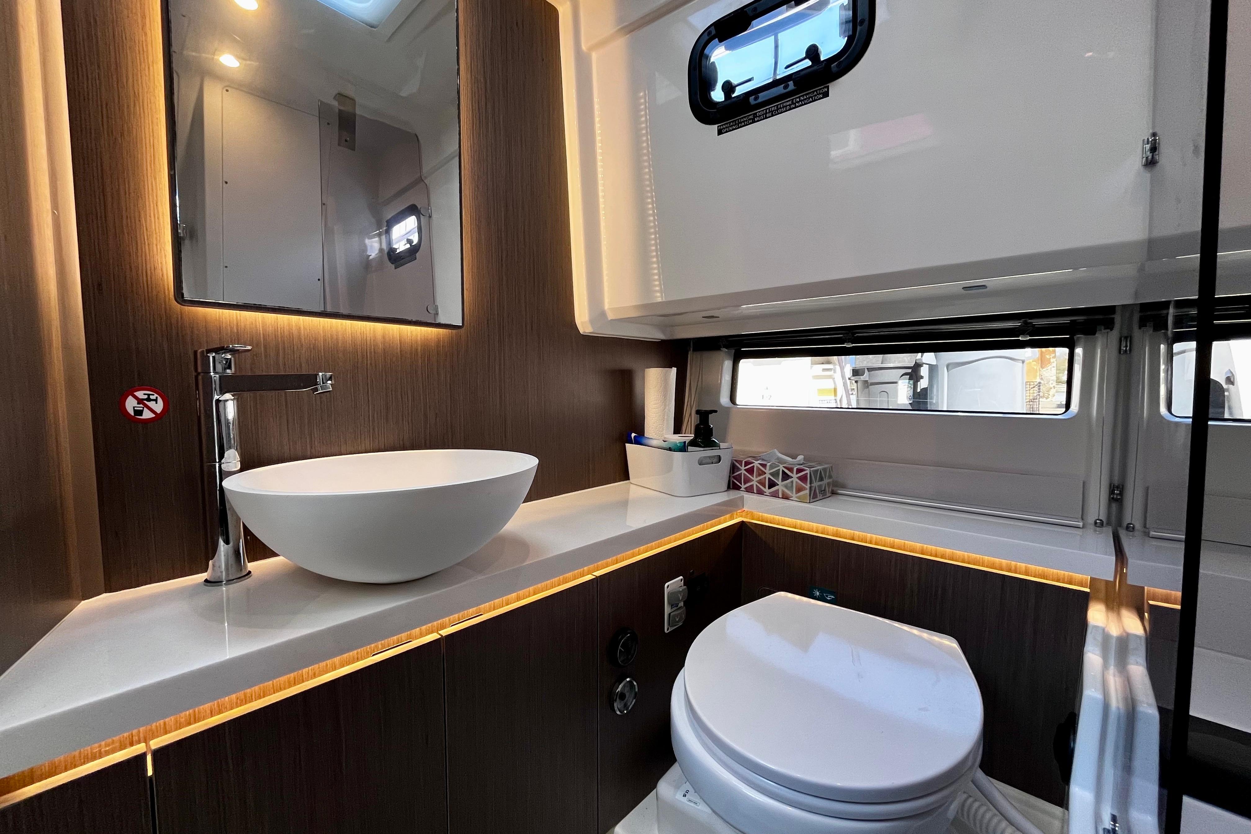 Luxurious bathroom in 2025 Wellcraft 38 Explorer yacht with modern fixtures and elegant design.