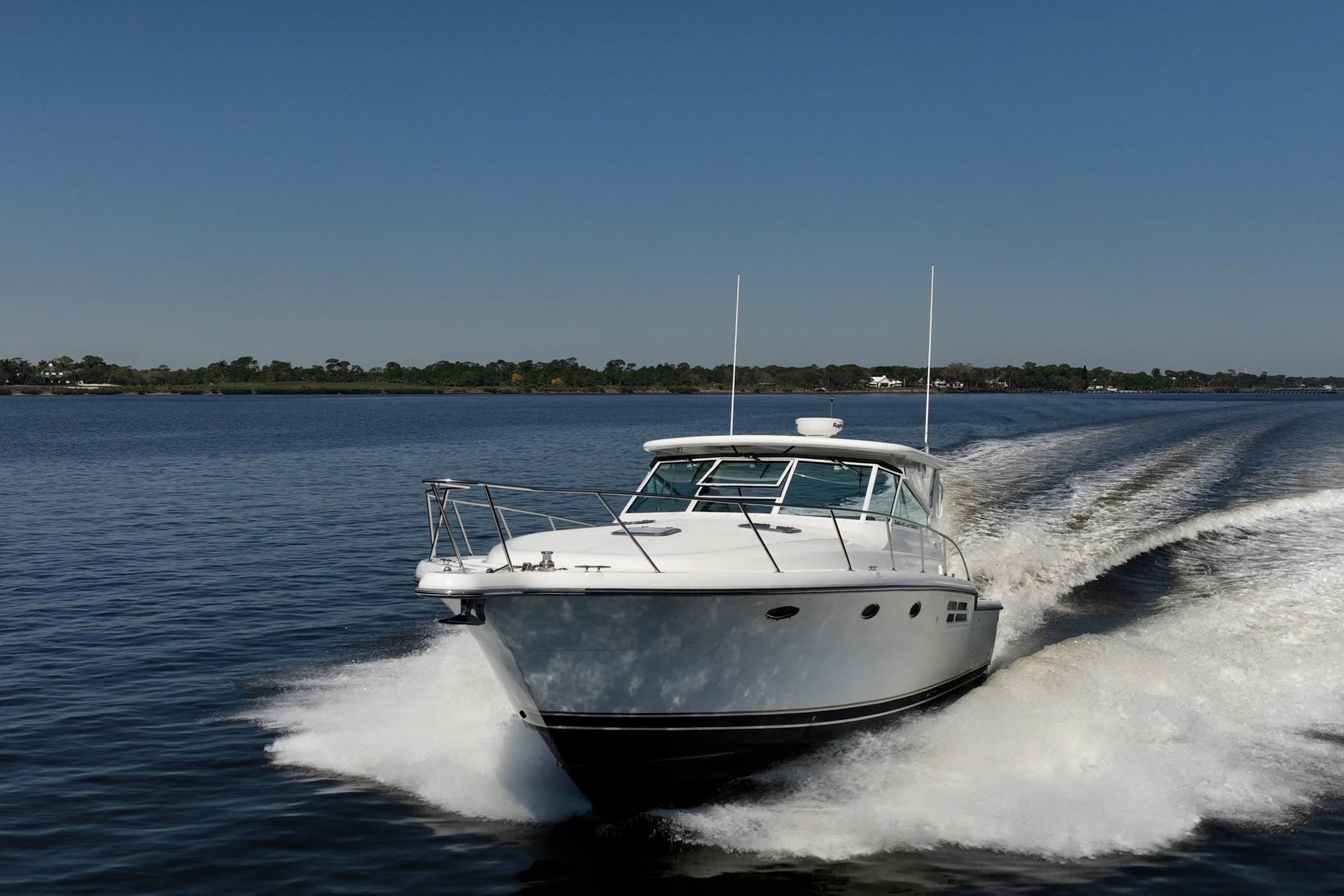 2002 Tiara Yachts 4100 Open cruising on a calm lake under clear blue skies.