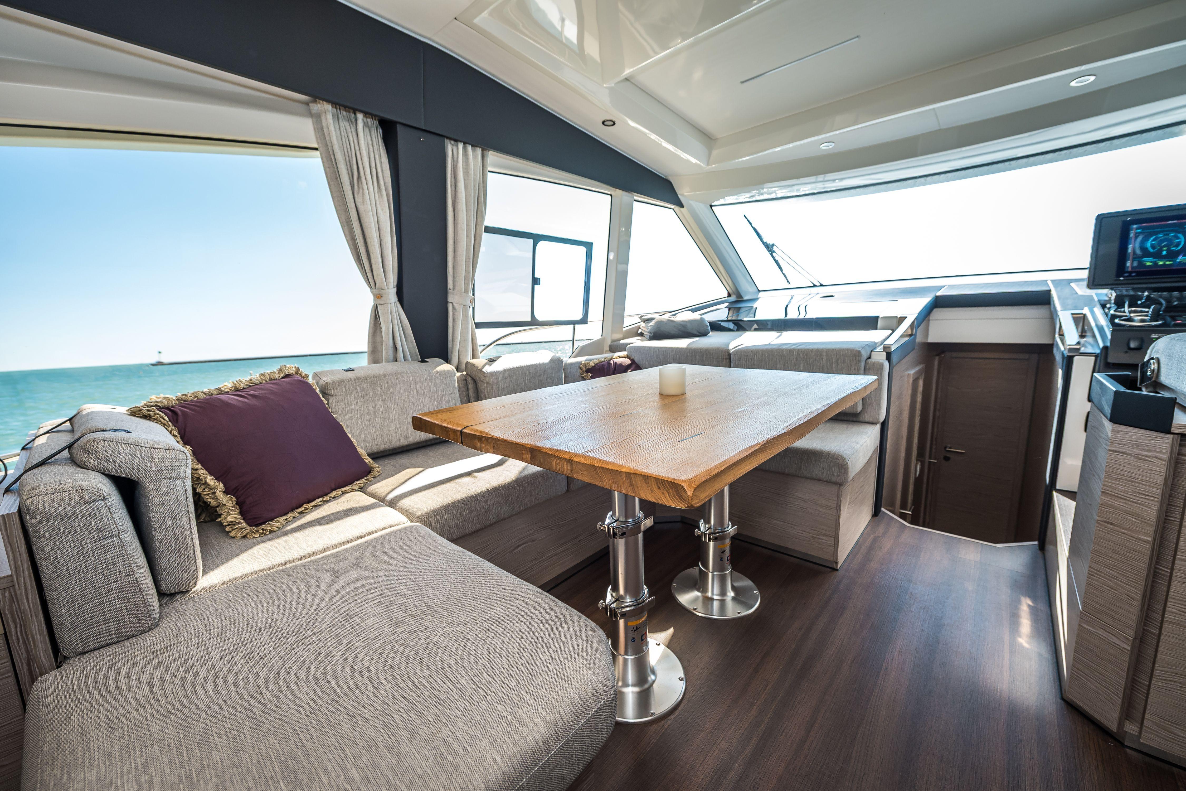 Luxurious interior of 2024 Greenline 45 Coupe Hybrid yacht with elegant seating and ocean view.