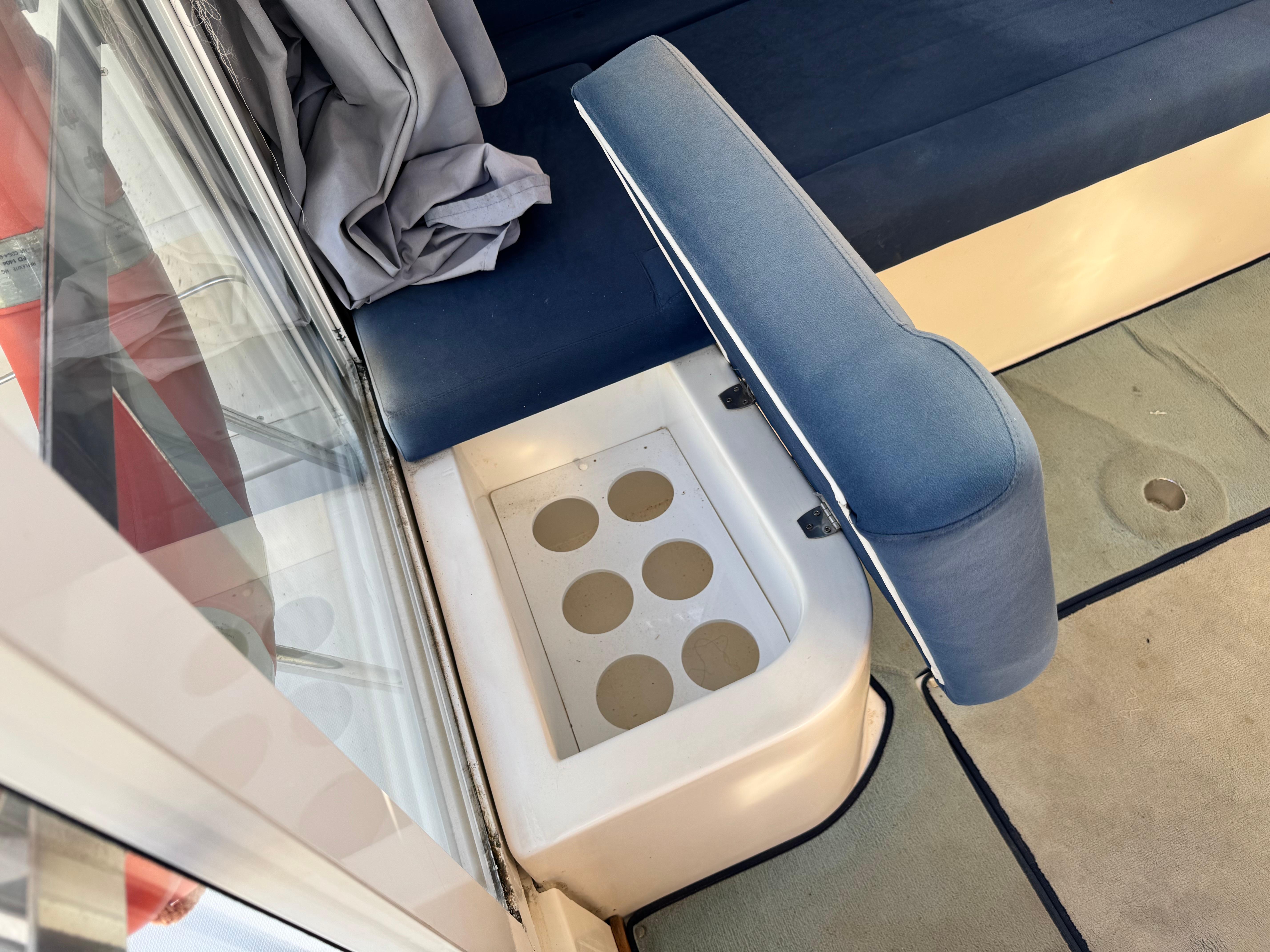 Interior of 2002 RIO 800 Cabin Fish boat with seating and cup holders.