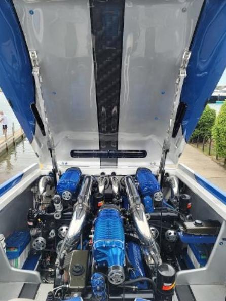 2009 Cigarette 46' Rider XP boat engine compartment with blue accents and open hatch.