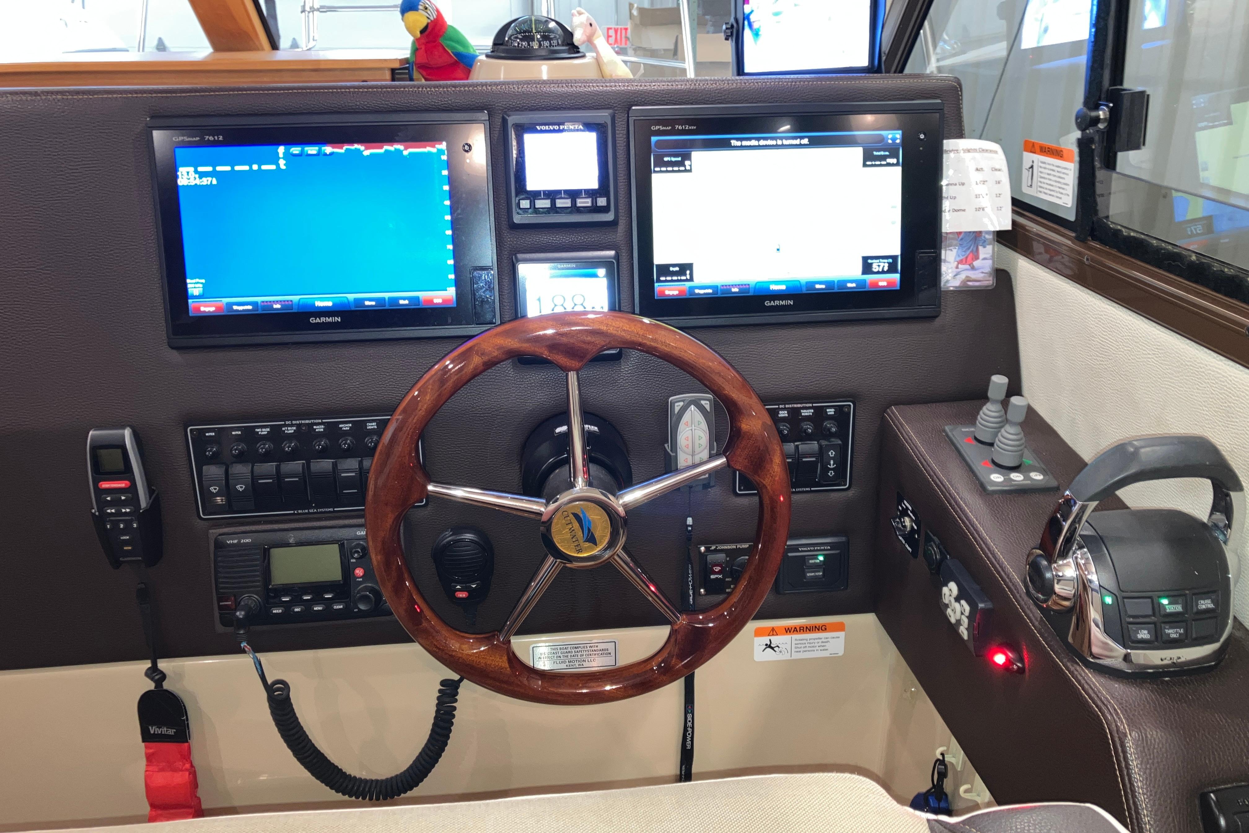 2017 Cutwater C-30 Sedan helm with Garmin displays, wooden steering wheel, and control panel.