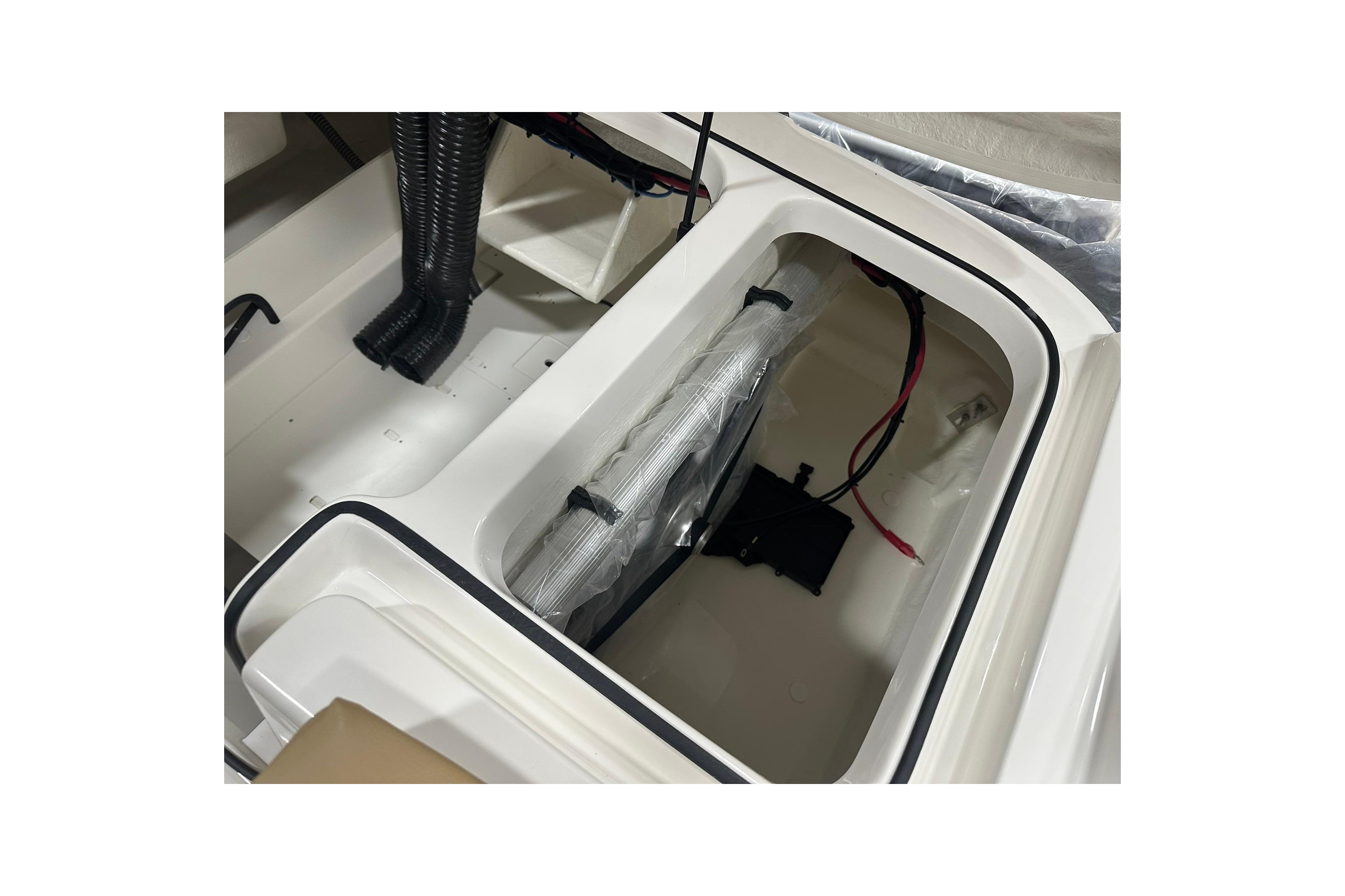 2026 Bayliner VR6 Bowrider OB interior storage compartment with wiring and ventilation.