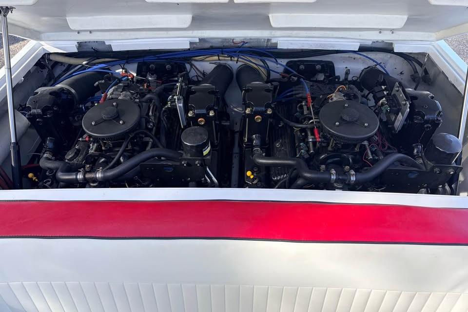 1983 Cigarette 24' Classic boat engine compartment with dual engines visible.