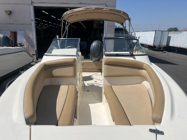 2019 Scout 210 Dorado boat with beige seating and canopy.