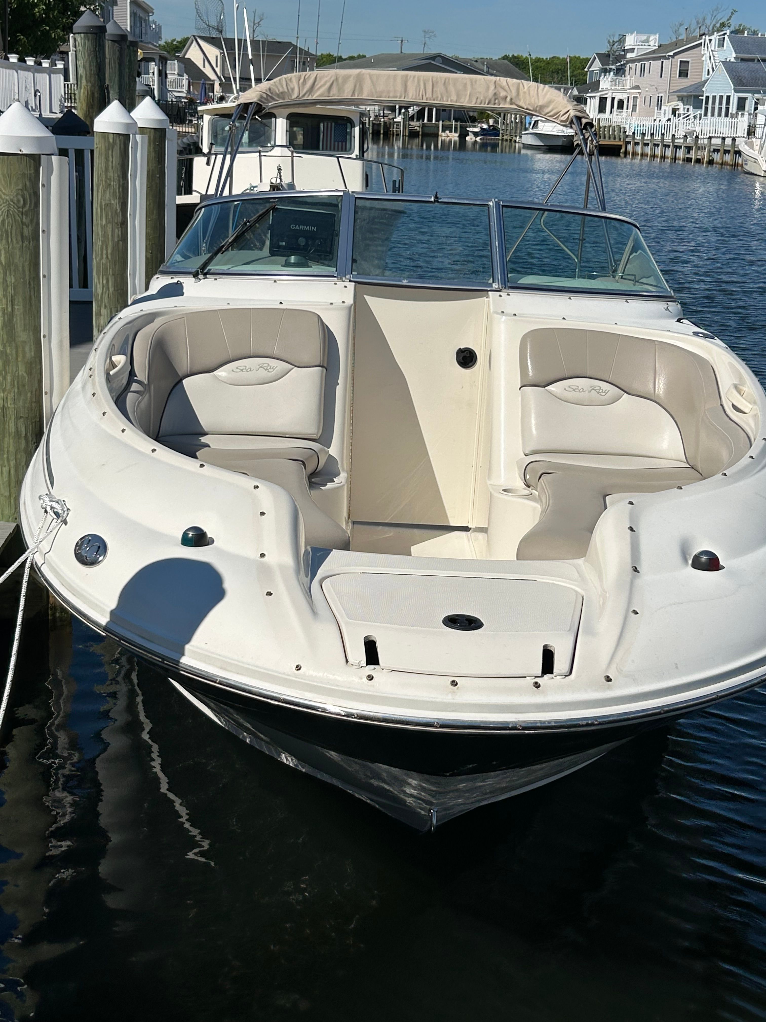 2003 Sea Ray 240 Sundeck boat docked at marina.