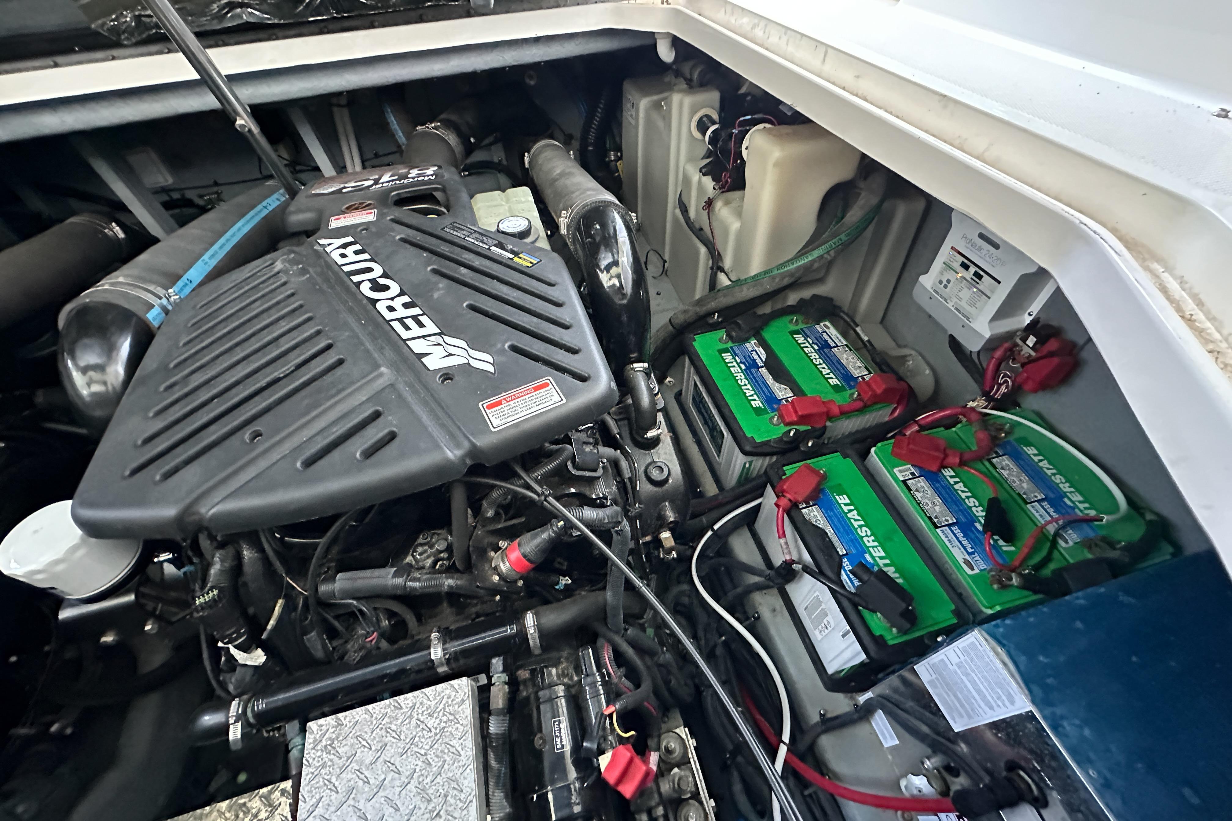 Engine compartment of a 2001 Sea Ray 410 Sundancer with Mercury engine and batteries.