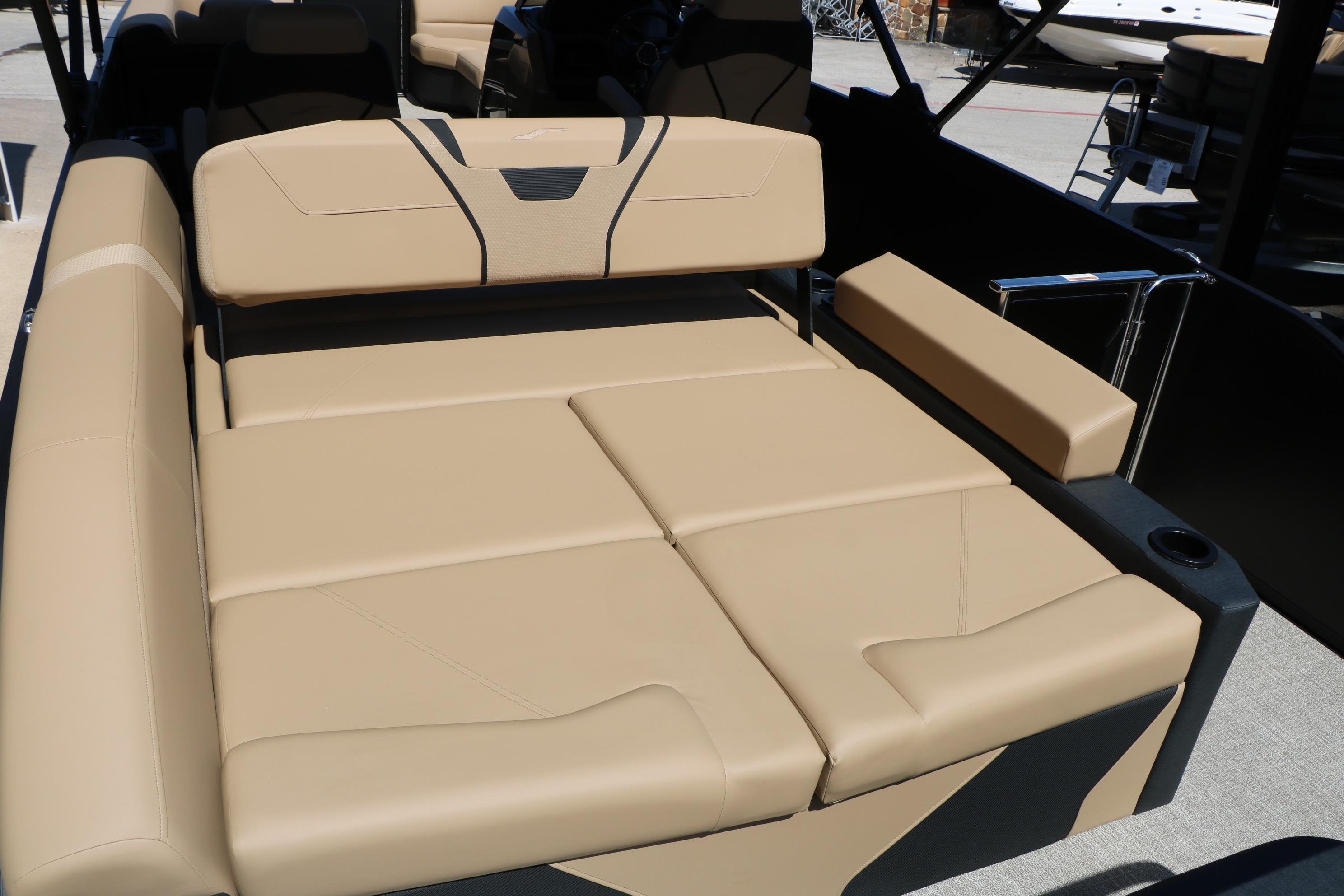Luxurious seating on 2026 Evotti 725 CS Tri-Toon boat, featuring beige upholstery.