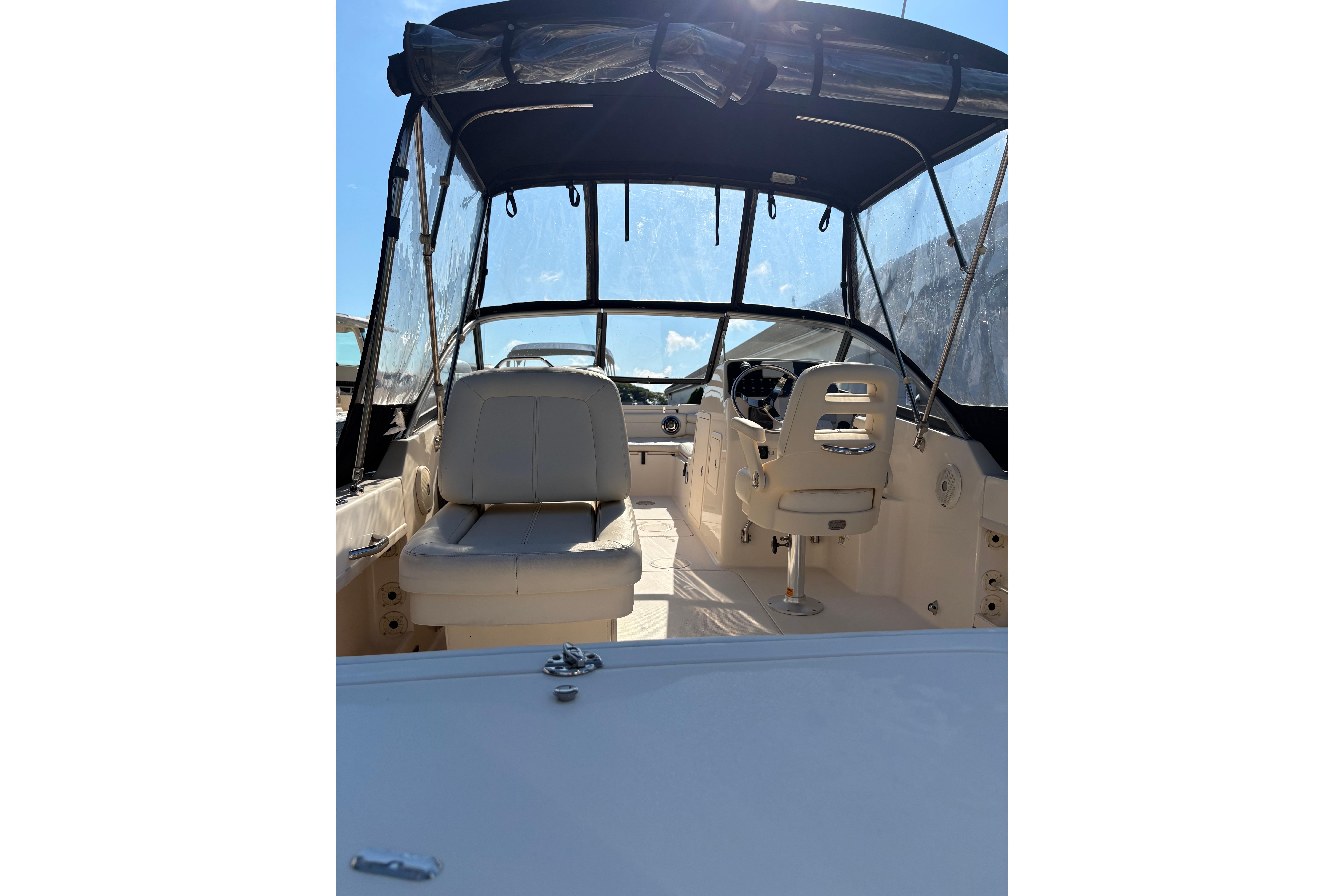2015 Grady-White Freedom 225 boat interior with seating and helm under canopy.