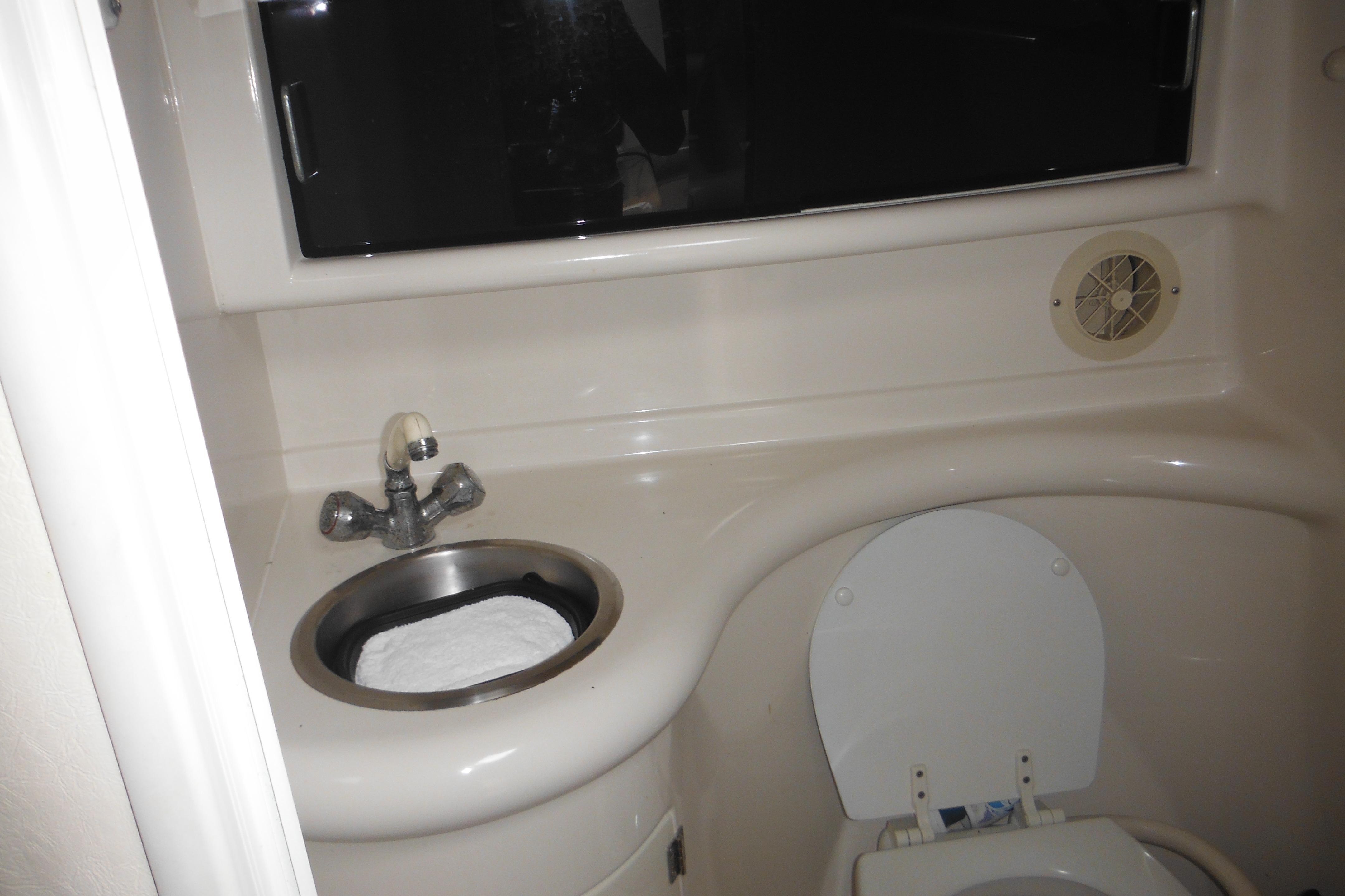 2001 Monterey 262 Cruiser bathroom with sink and toilet, featuring compact design.