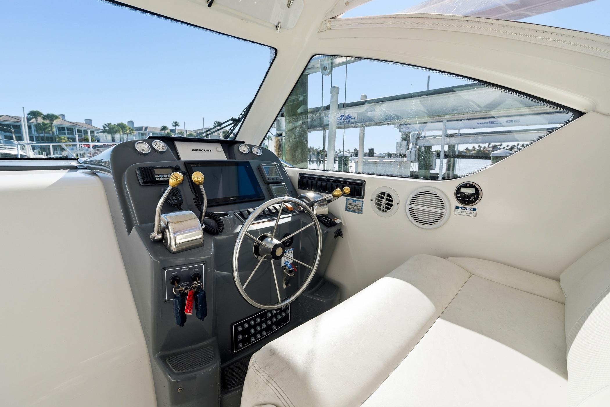 2007 Tiara Yachts 3000 Open helm with steering wheel and control panel.