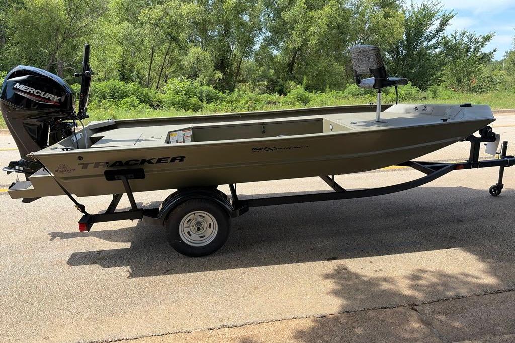 2026 Tracker Grizzly 1654 T Sportsman boat on trailer, parked outdoors.