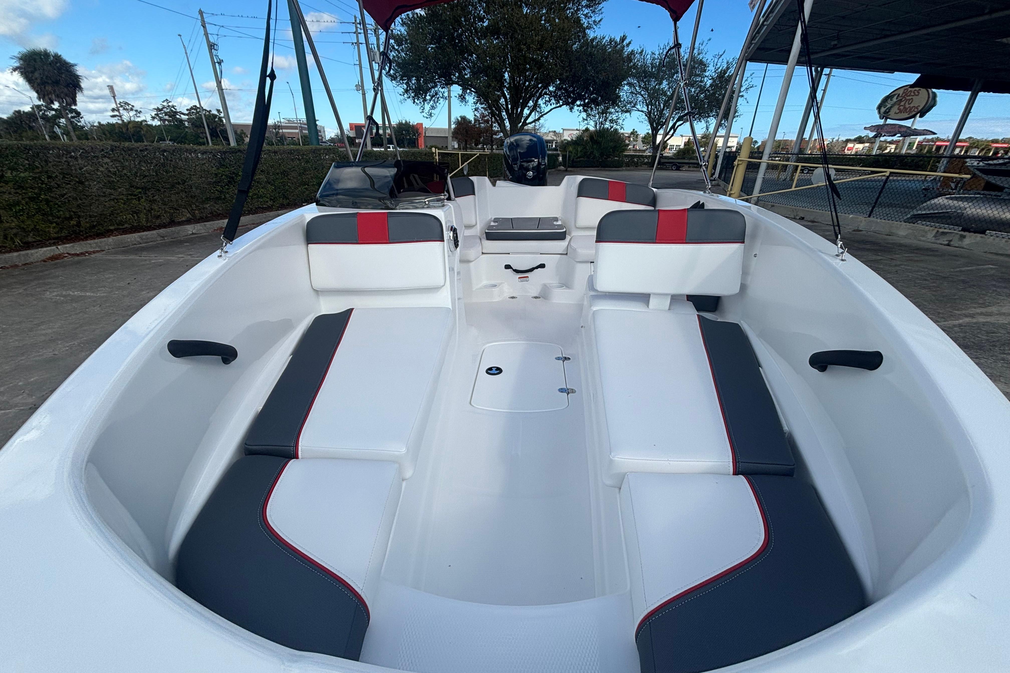2026 Tahoe T16 boat interior with white and gray seating, red accents, and open deck layout.