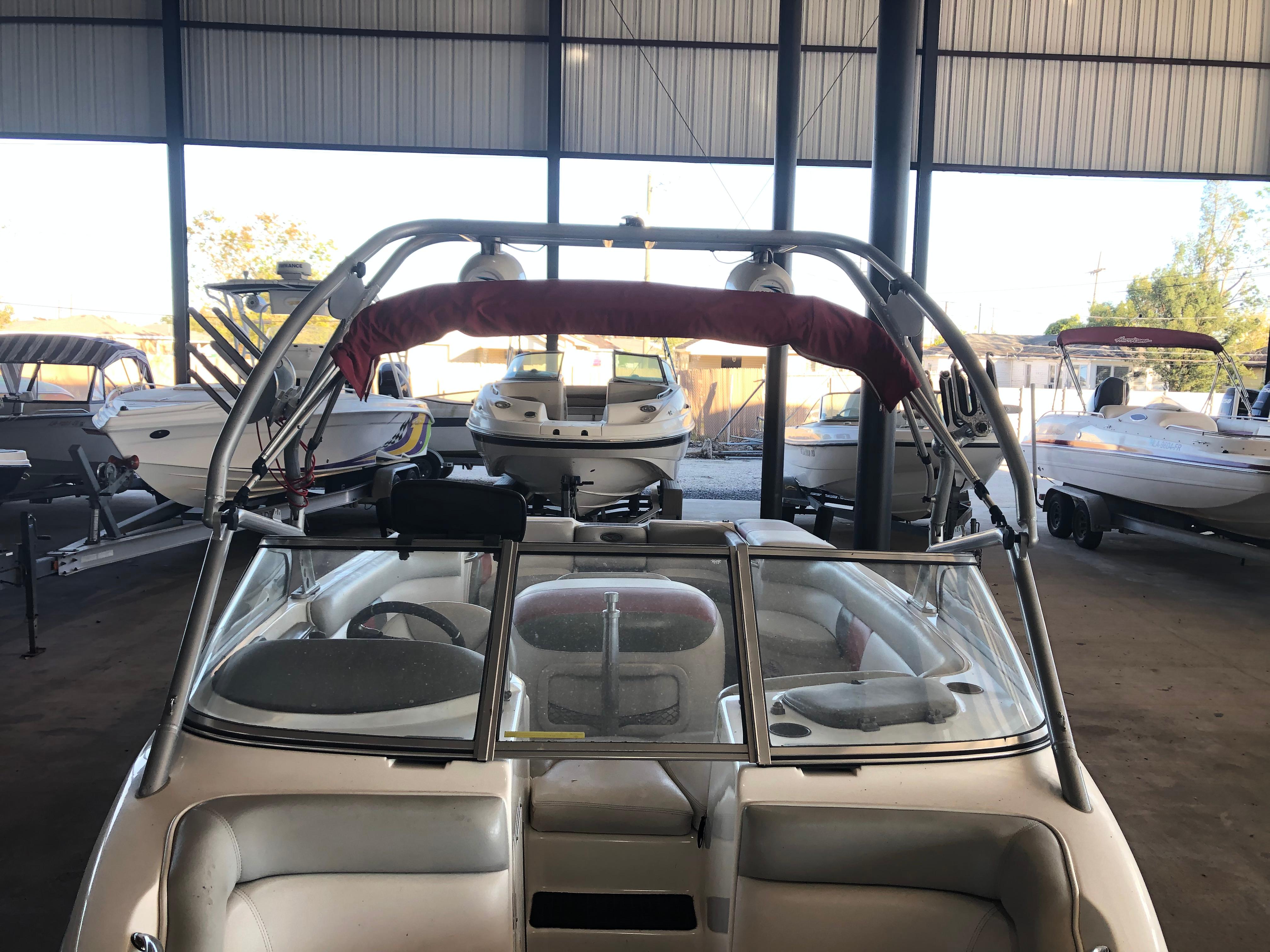 2004 Tigé 22I TYPE R boat in storage, surrounded by other boats.