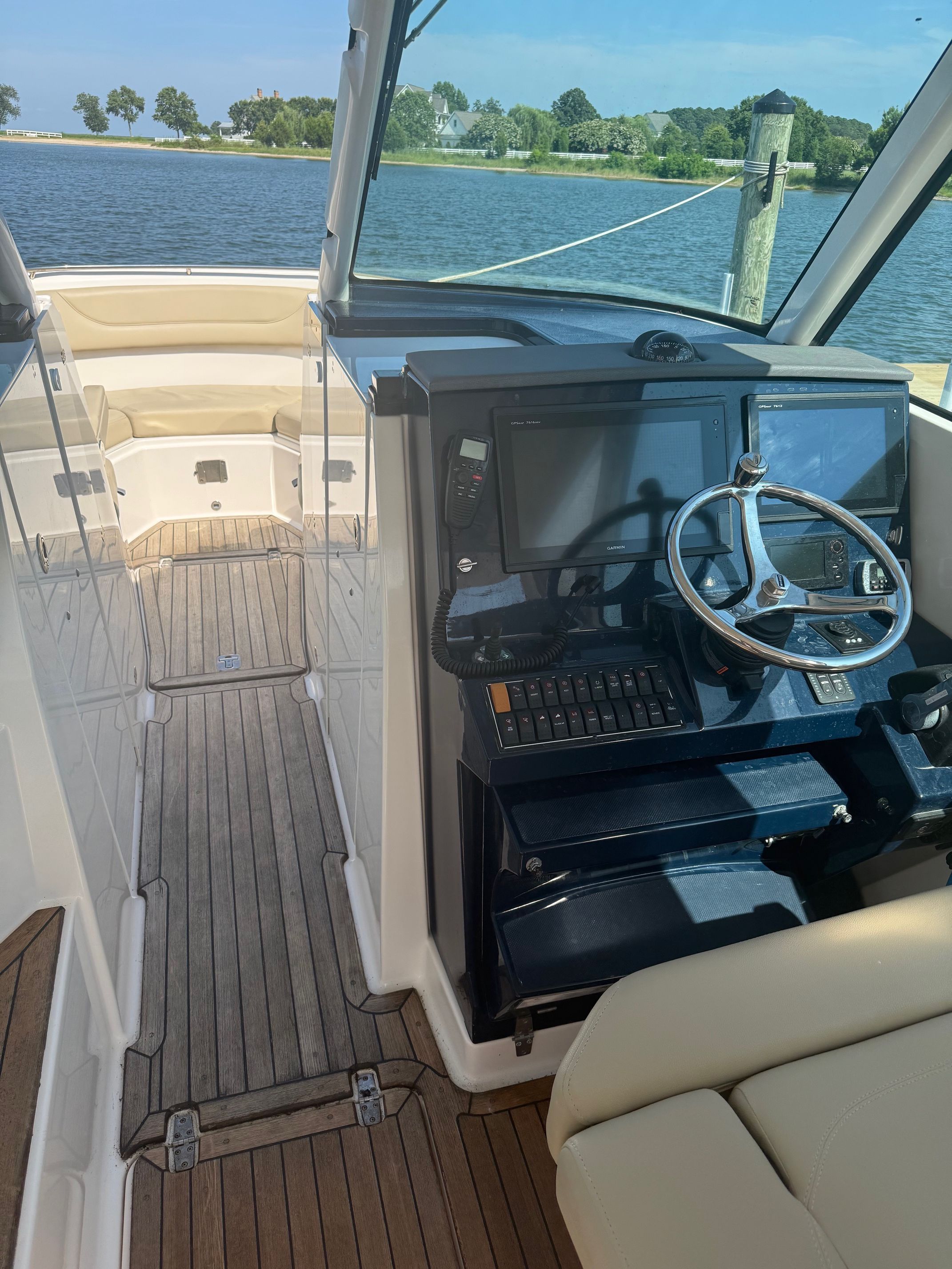 The image shows the cockpit of a 2016 Pursuit DC 325 Dual Console with modern electronics.