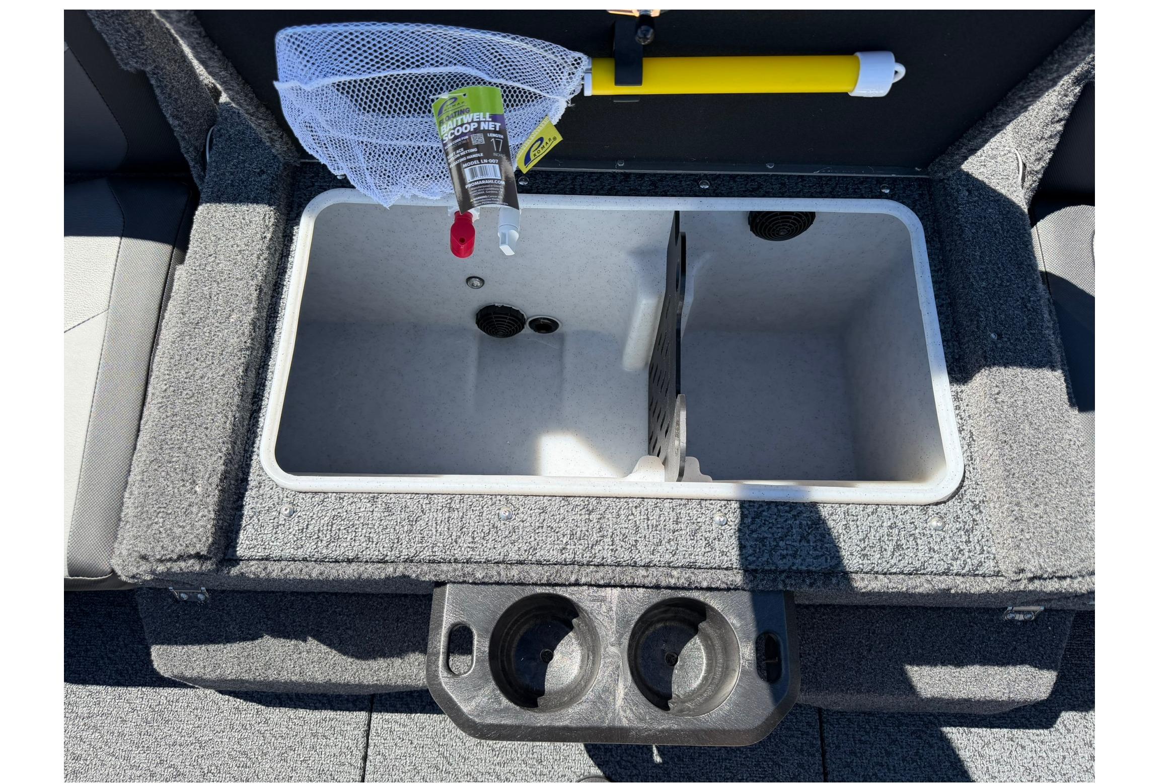 Livewell compartment in 2027 Lund 1775 Impact XS Sport boat with fishing net and cup holders.