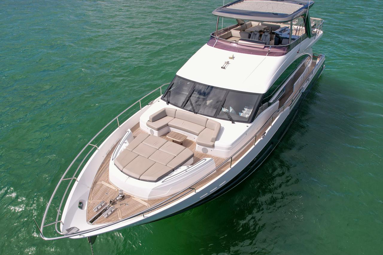 Luxury 2021 Princess Y78 yacht cruising on clear green waters.