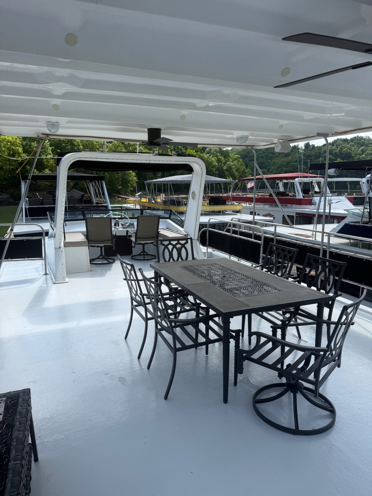 Deck of a 2003 Lakeview 16x70 houseboat with dining table.