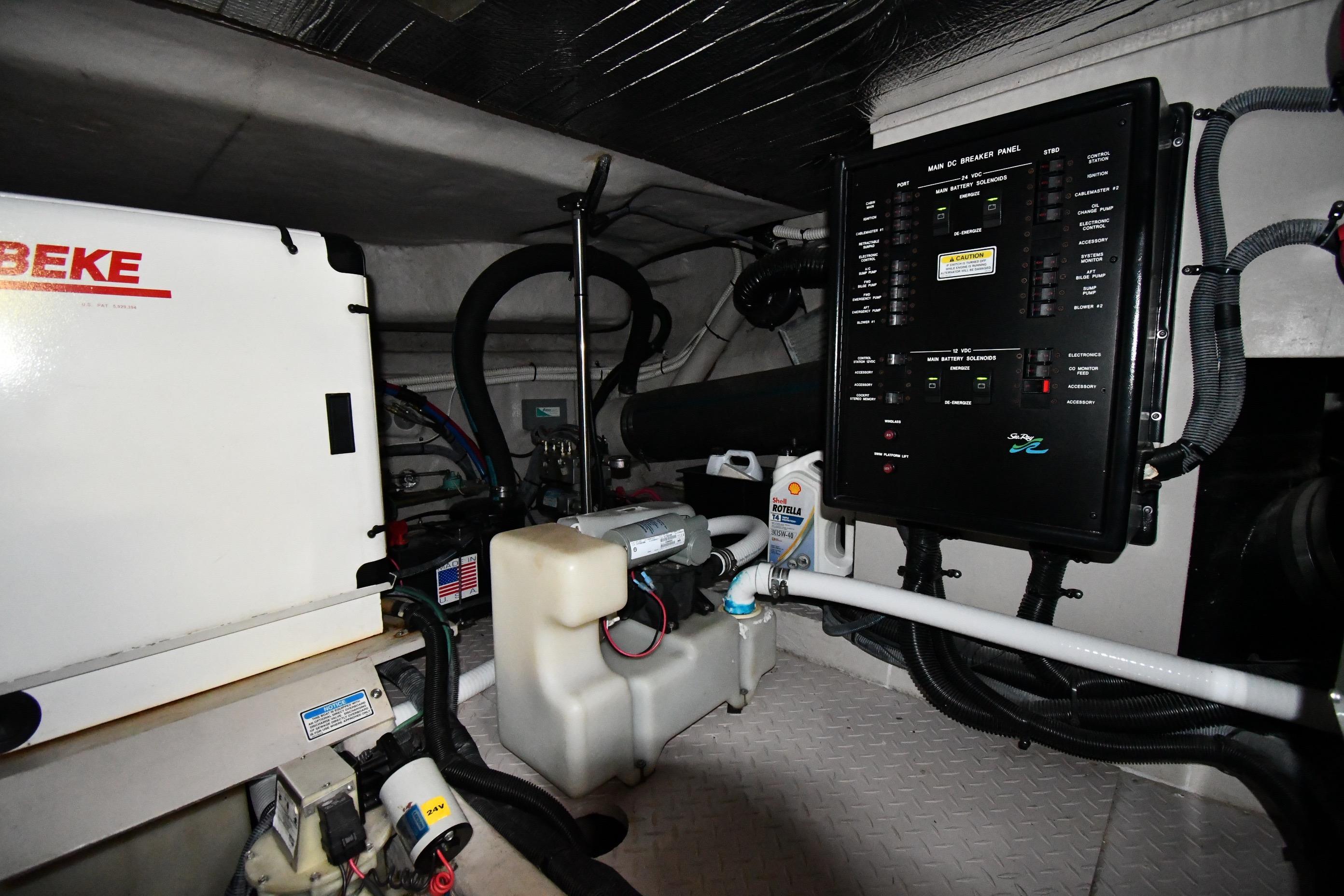 Engine room of 2001 Sea Ray 540 Sundancer with control panel and equipment.