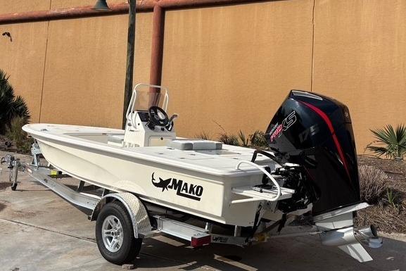 2026 Mako 18 Pro Skiff boat on trailer, outdoor setting.