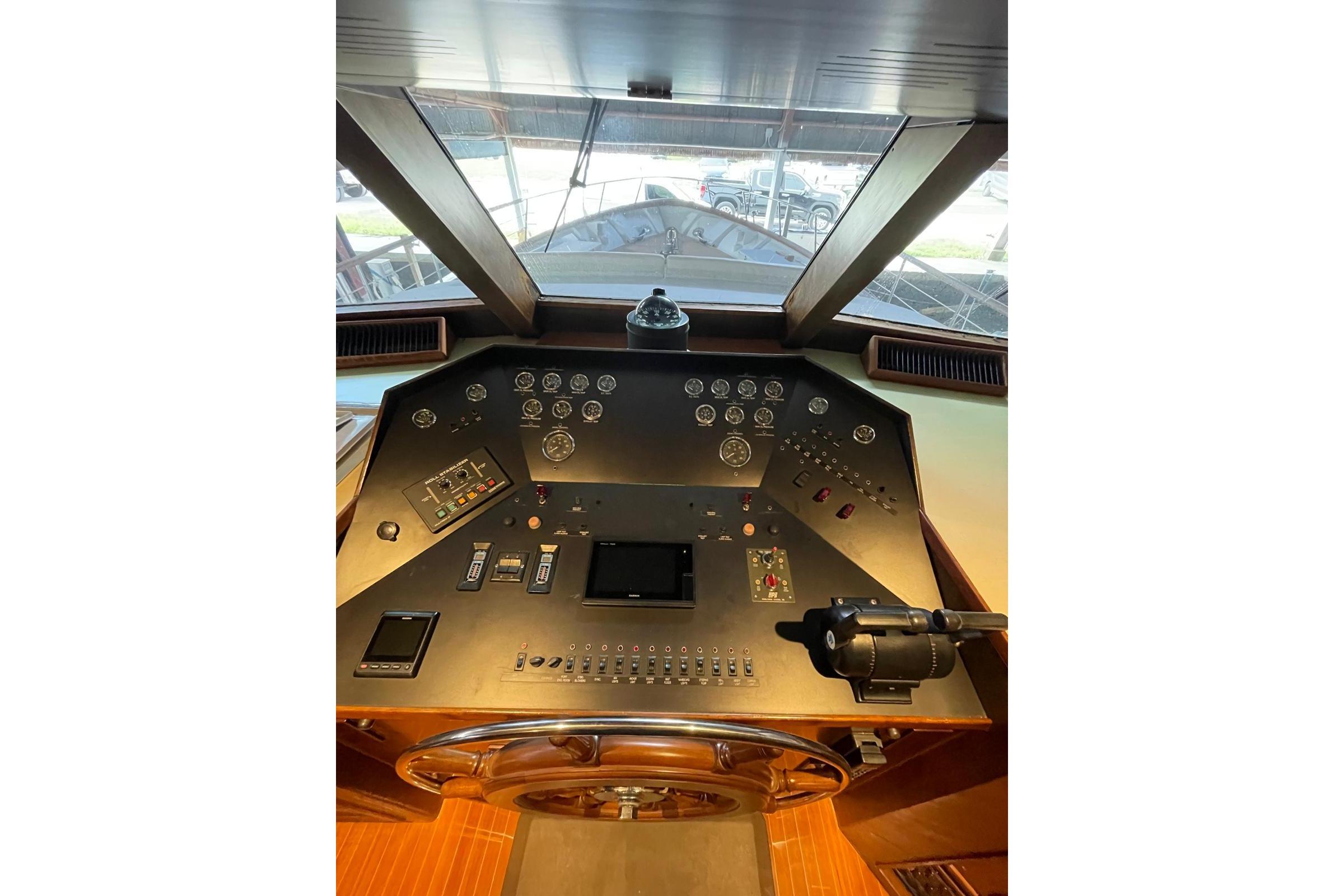 Cockpit of 1988 Burger Classic Motoryacht with control panel and steering wheel.