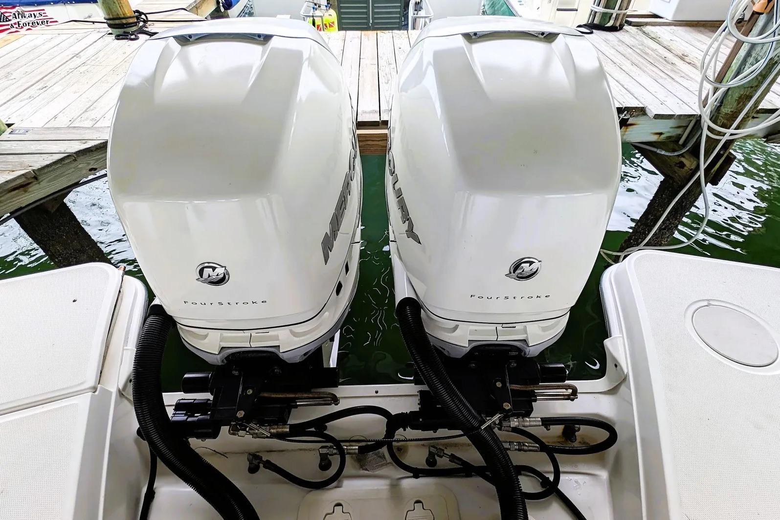 Twin Mercury FourStroke engines on a 2017 Boston Whaler 320 Vantage boat at dock.