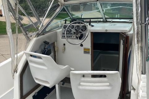 Interior view of a 1987 Aquasport 222 Express Fisherman with helm and seating.