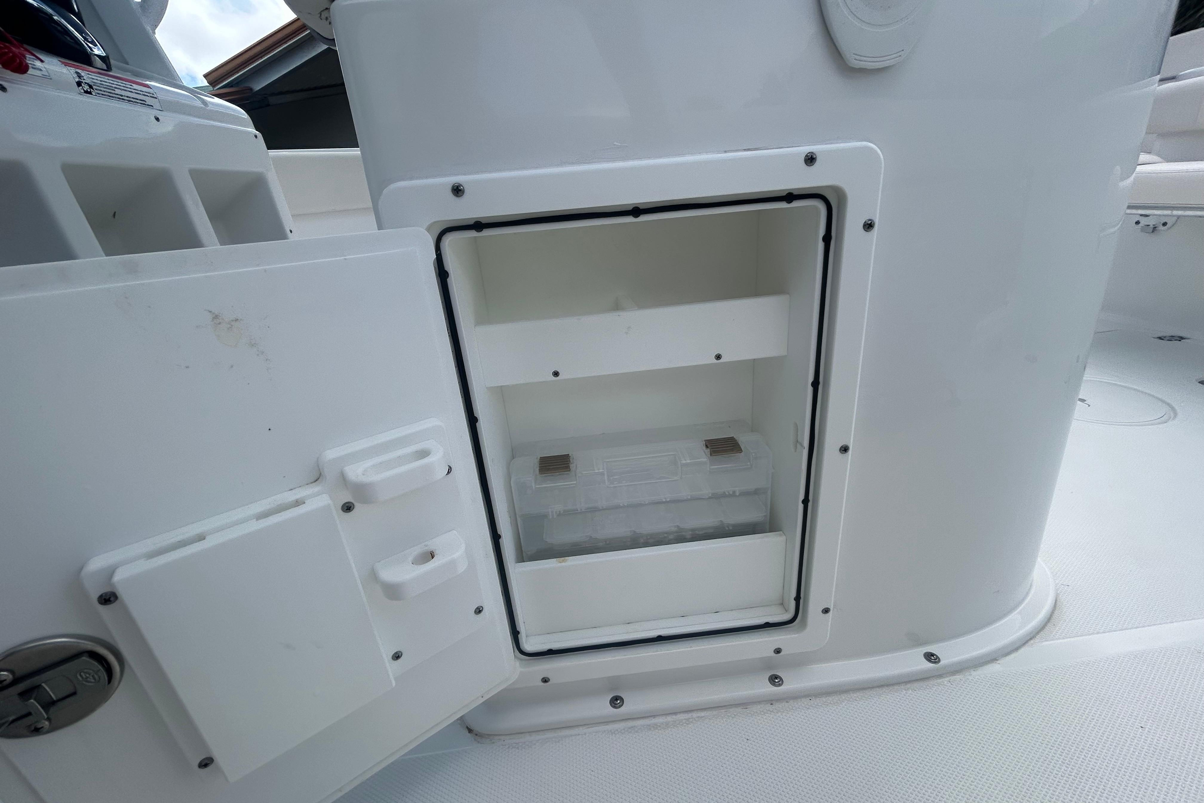 2023 Sea Hunt Gamefish 27 Coffin Box storage compartment, open and empty.