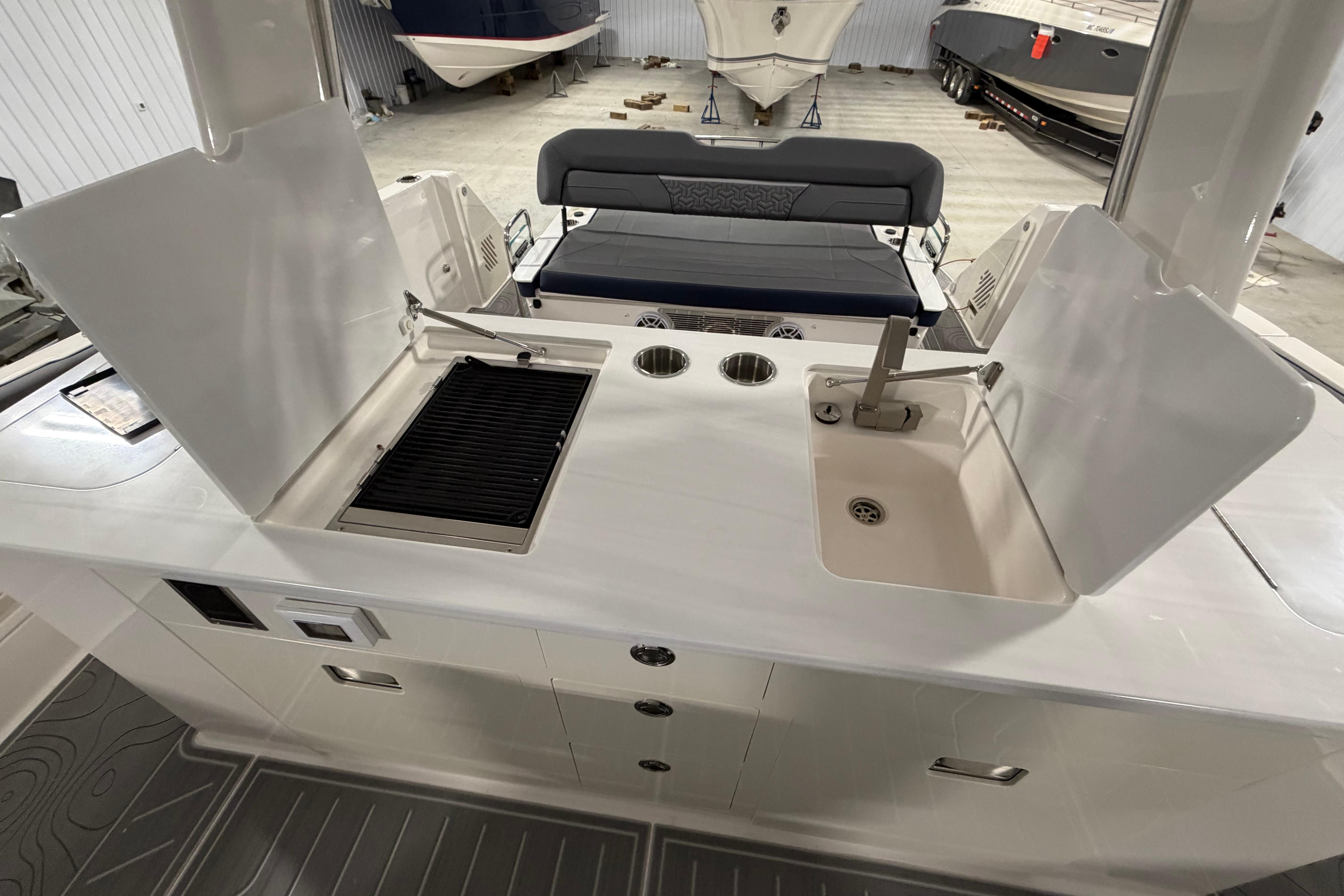 2027 Regal 38 Surf boat interior with grill and sink in a spacious layout.