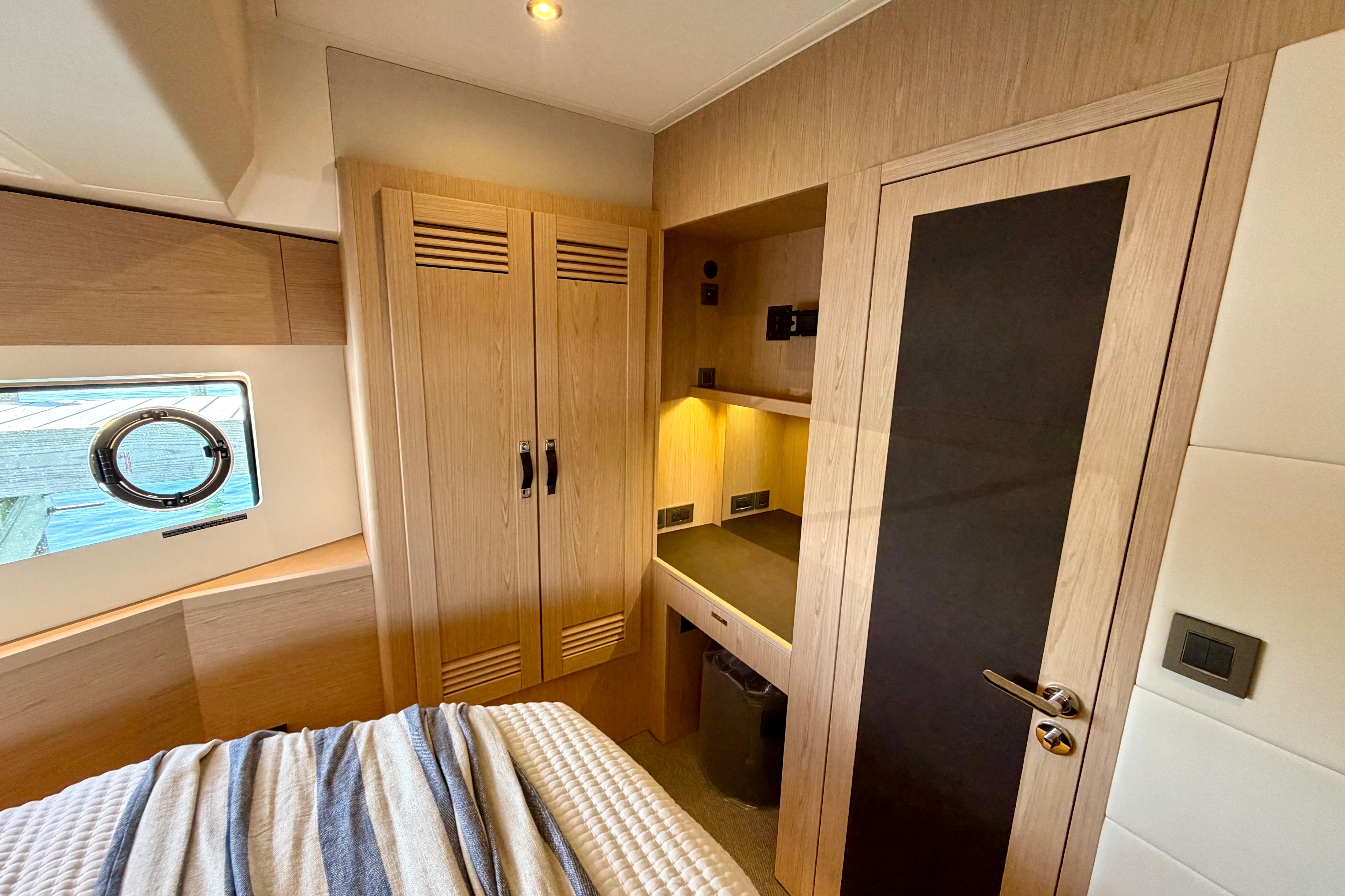 Interior of 2026 Beneteau Swift Trawler 54, featuring wood cabinetry and modern design.