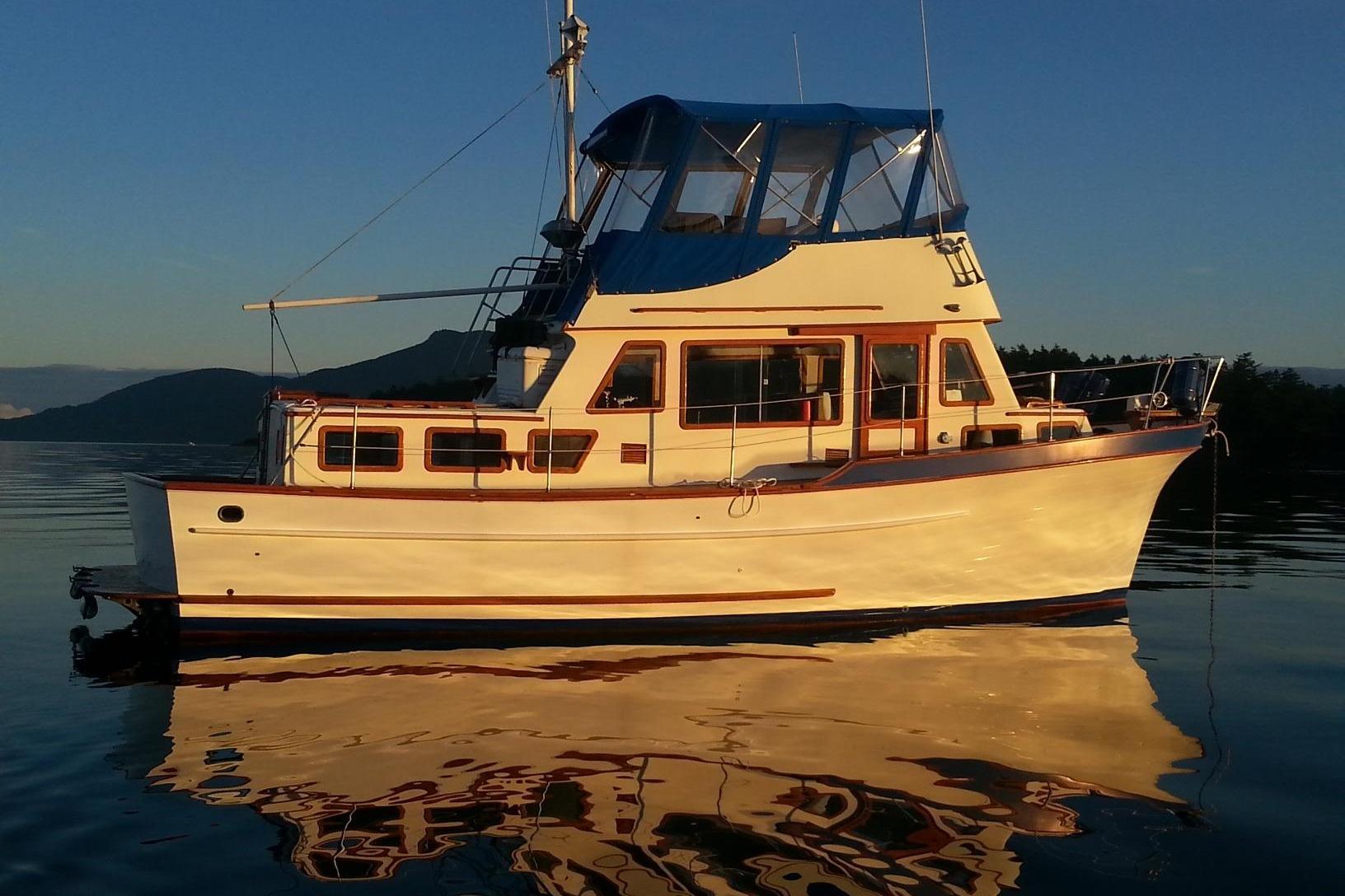 1979 Transpac Eagle 36 Trawler on calm water at sunset.