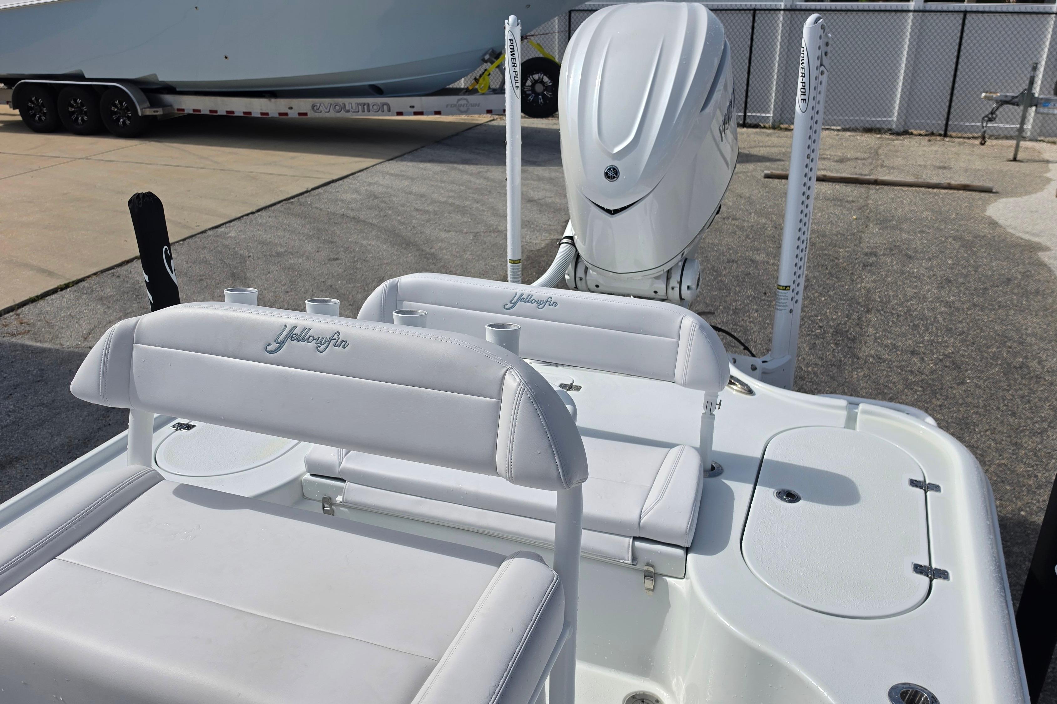2026 Yellowfin 24 Bay CE boat with white seating and powerful outboard motor.