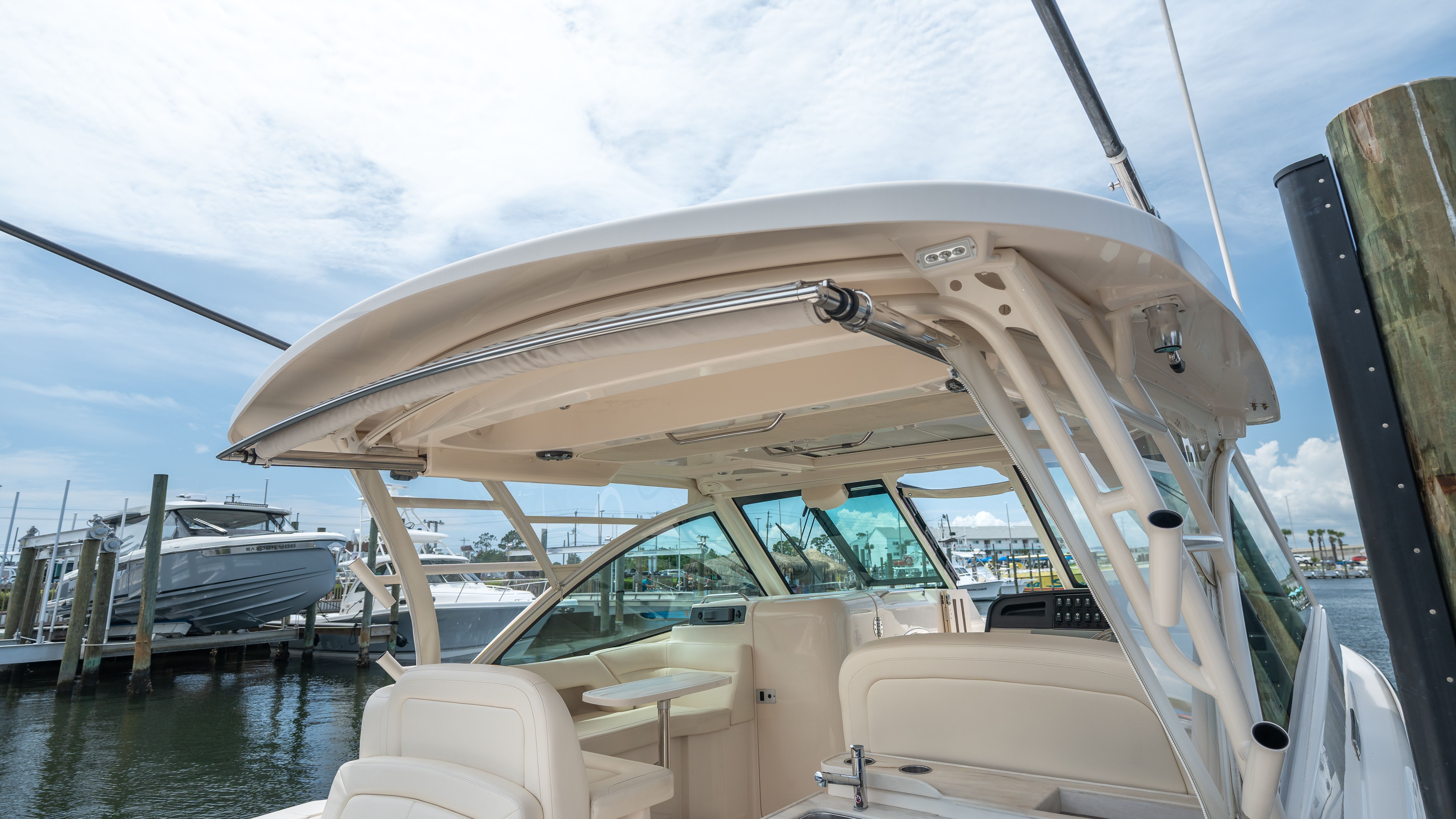 The image shows the cockpit of a 2019 Grady-White 375 Freedom with a sturdy hardtop.