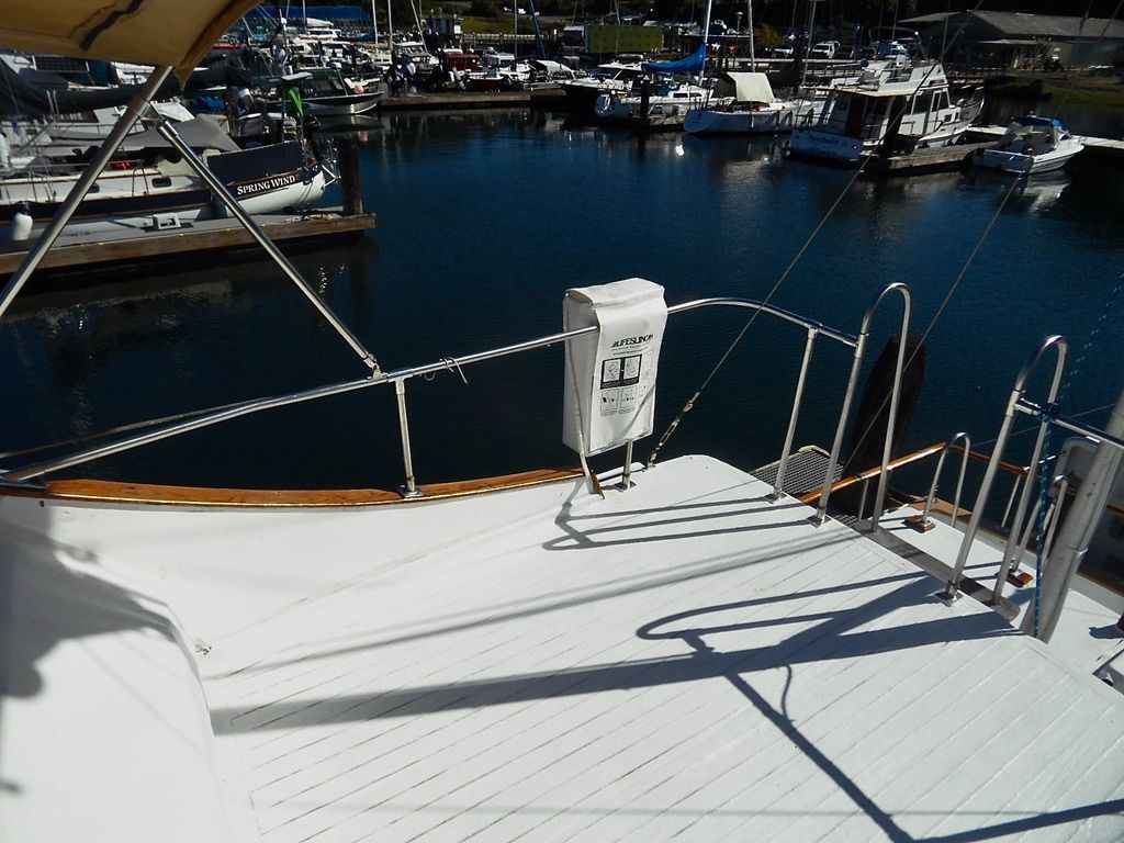 1976 CHB Trawler deck overlooking marina with various boats docked.