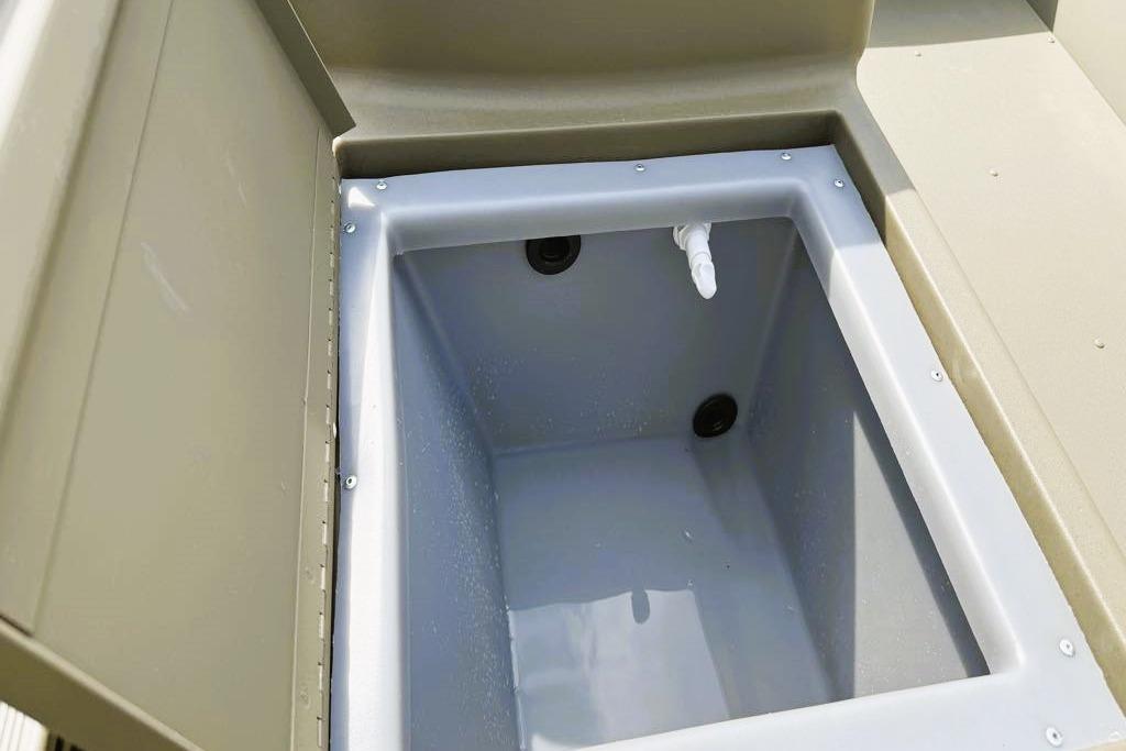2026 Tracker Grizzly 1648 SC boat storage compartment, open lid, interior view.