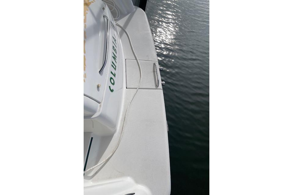 1999 Formula 400 Super Sport boat deck with water reflection.