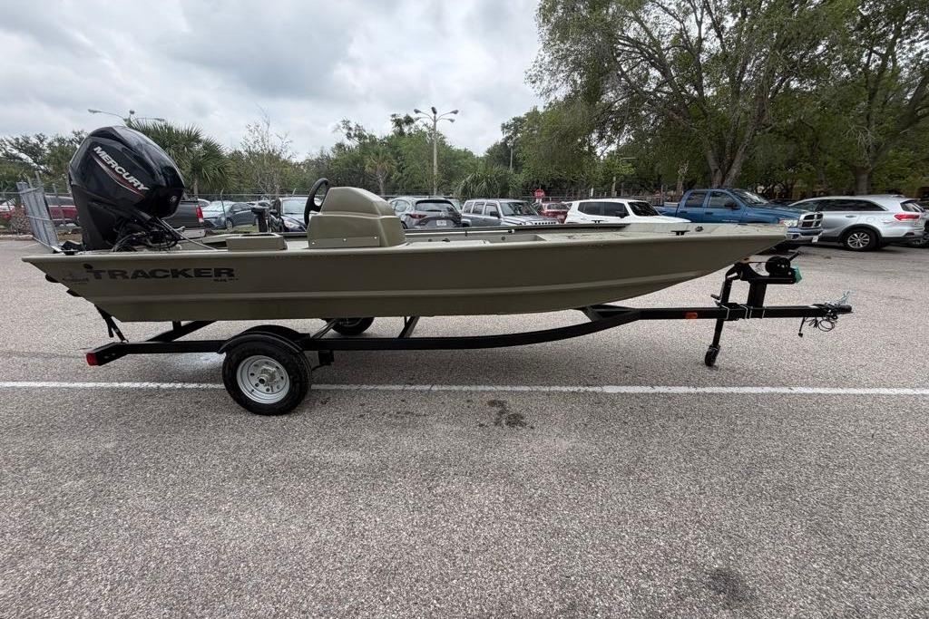 2026 Tracker Grizzly 1648 SC boat on trailer in parking lot.