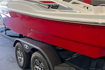 2025 Tahoe T21 boat on trailer, red and white design, side view.