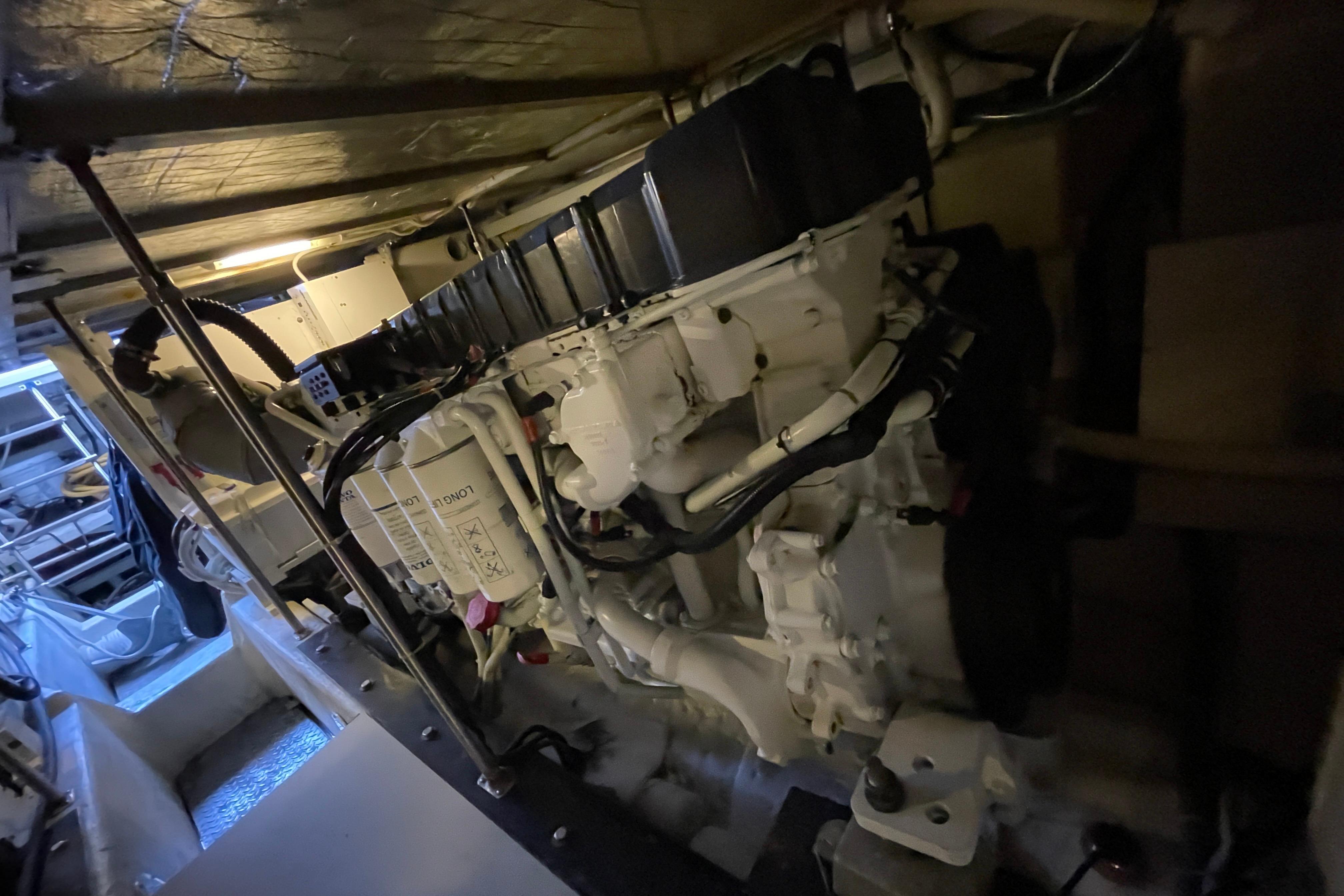 Engine room of 2002 Carver 570 Voyager Pilothouse, showcasing mechanical components.