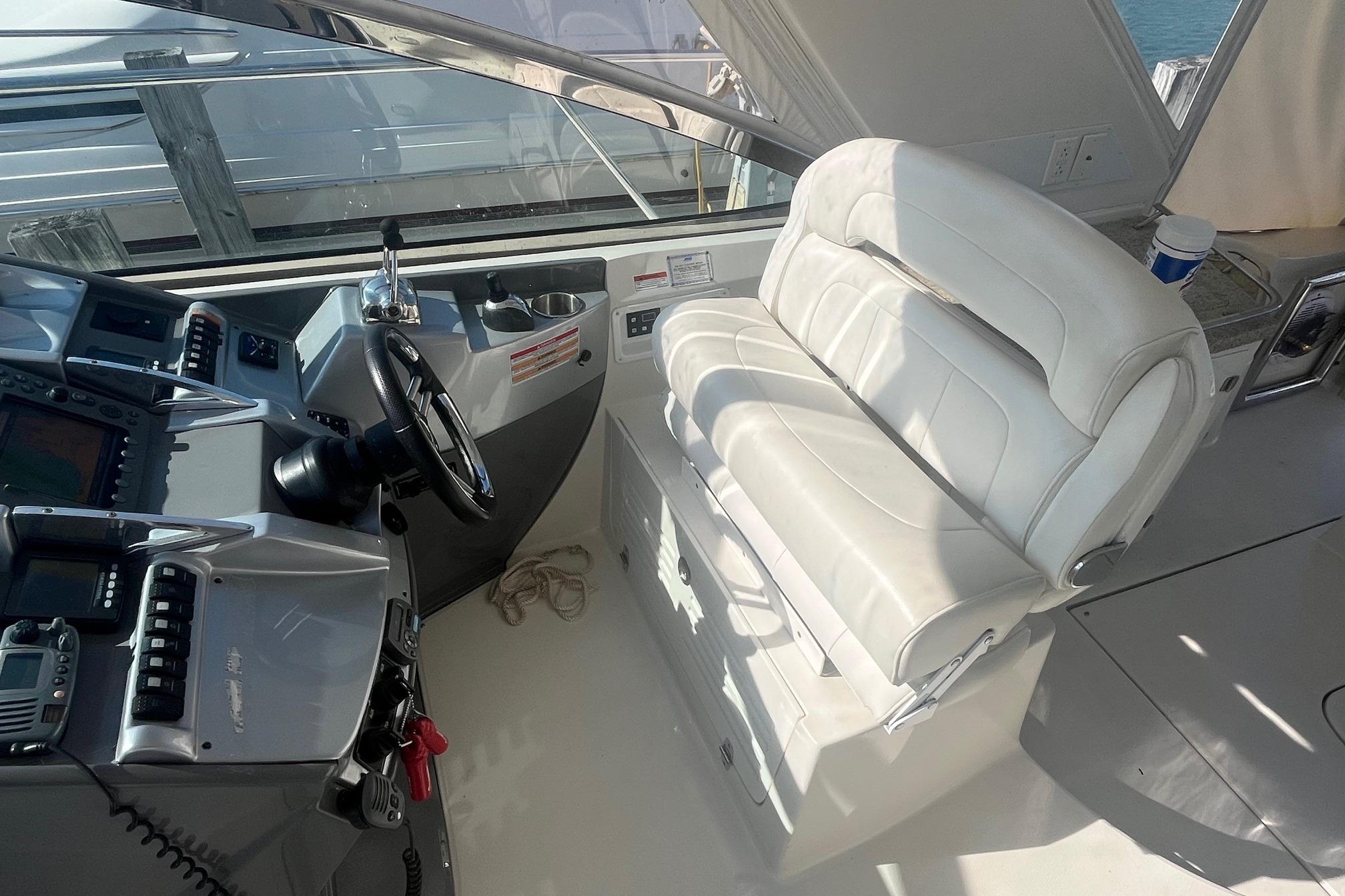 Cockpit of 2010 Monterey 400 Sport Yacht with white leather seating and control panel.