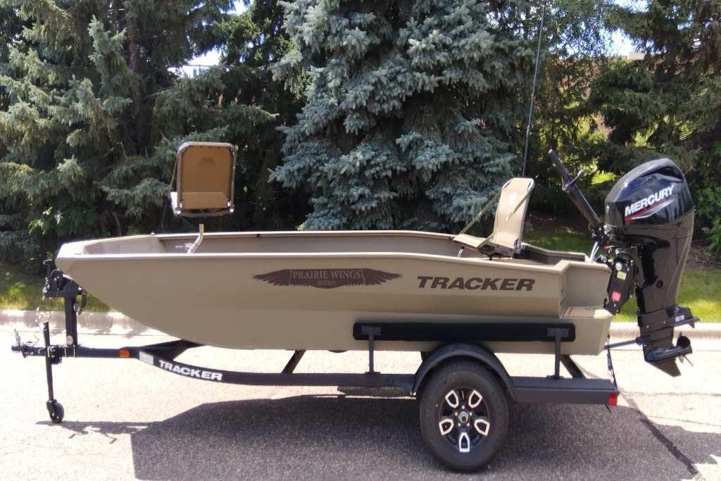 2026 Tracker Grizzly 1650 T Prairie Wings Edition boat on trailer, outdoors.